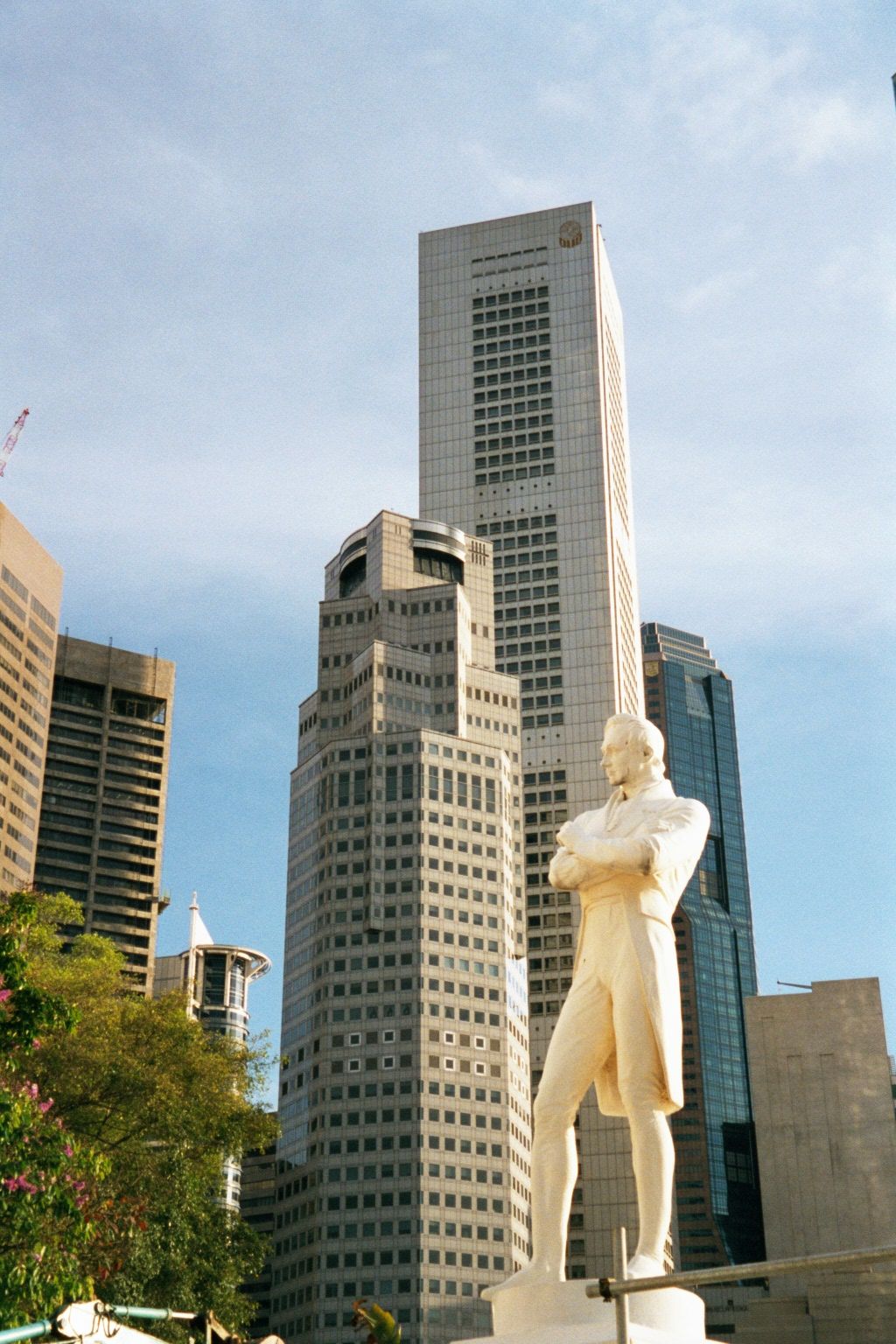 Raffles, backed up by bank towers.