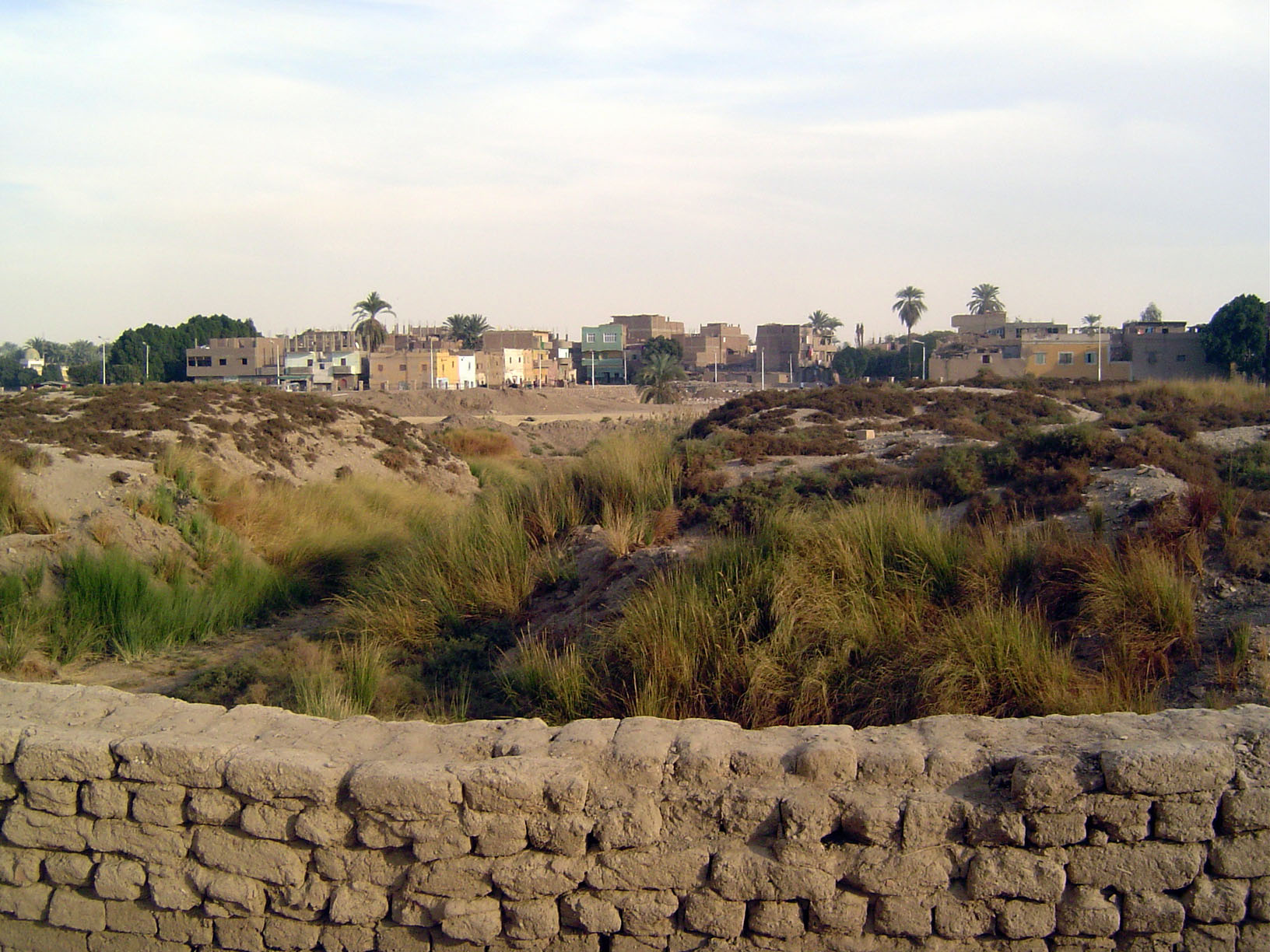 Looking east beyond the enclosure wall. Just dirt? Not quite: it's the remains of a temple built by Amenhotep IV or Akhenaten.