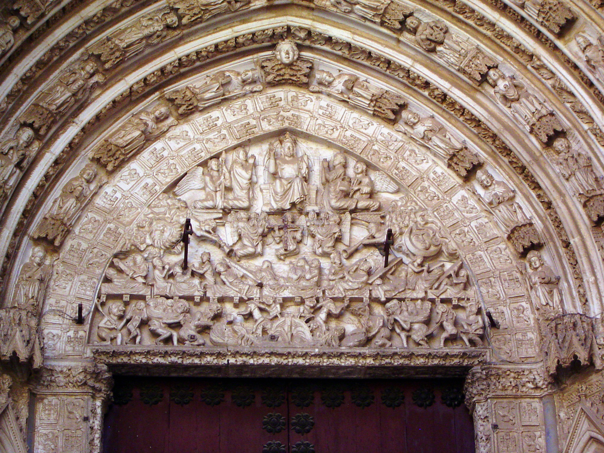 The door on the right is the Puerta del Juicio, or Door of the Day of Judgment.