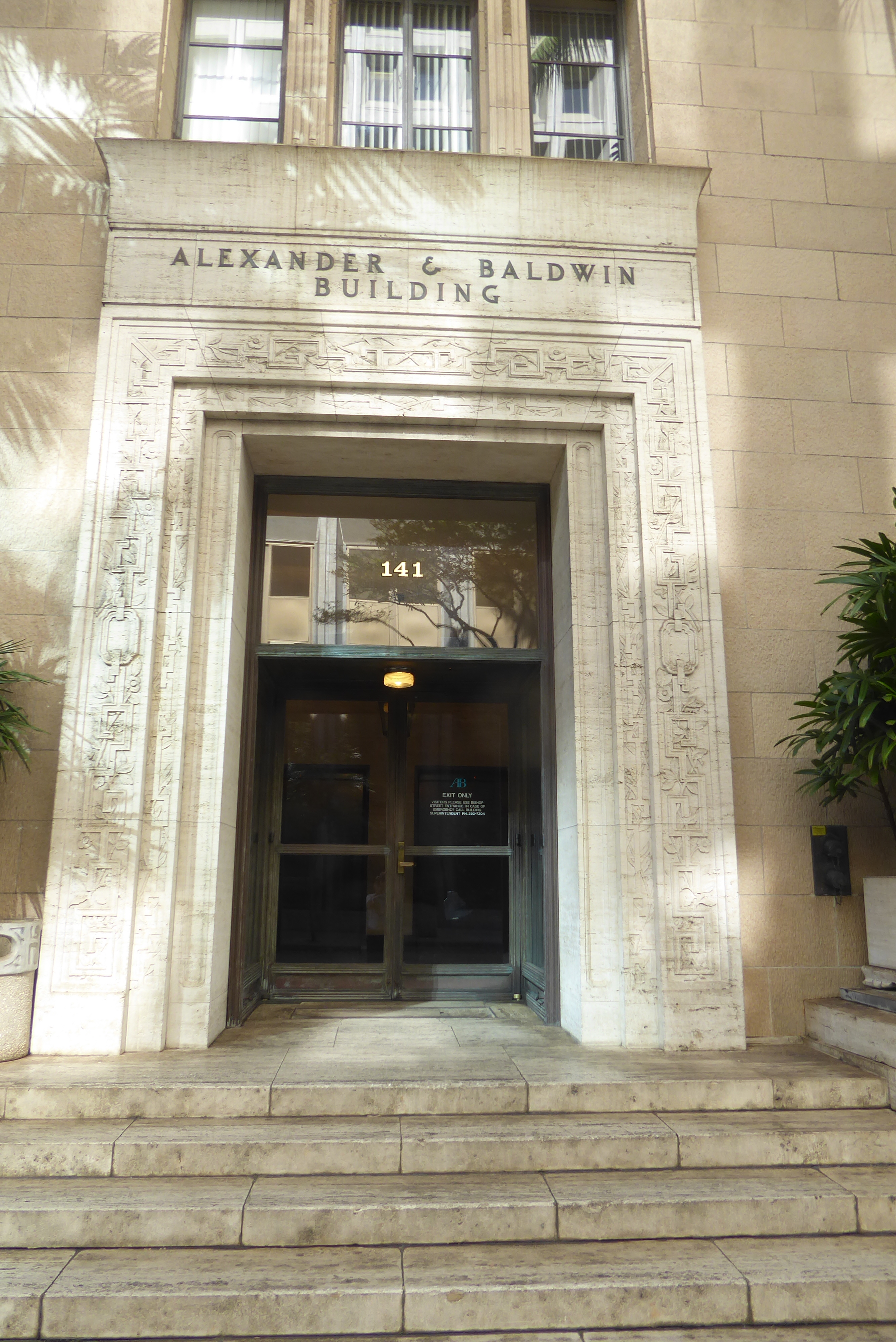 The architect was C.W. Dickey 1871-1942, an MIT graduate whose career was spent in Honolulu. The material is terracotta.