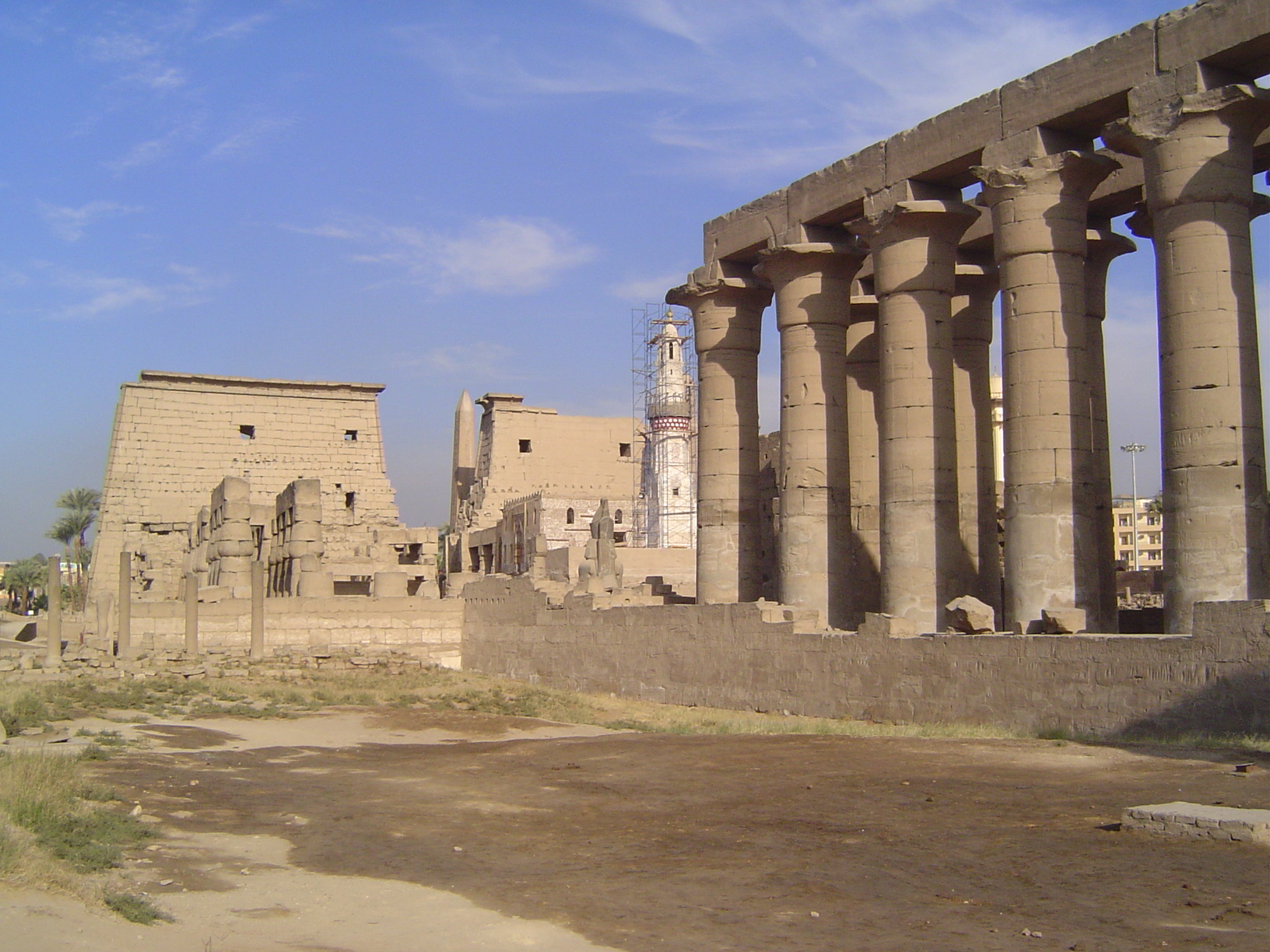 The colonnade is shown here together with the first courtyard and first pylon. A much more recent white mosque stands at the corner of the c
