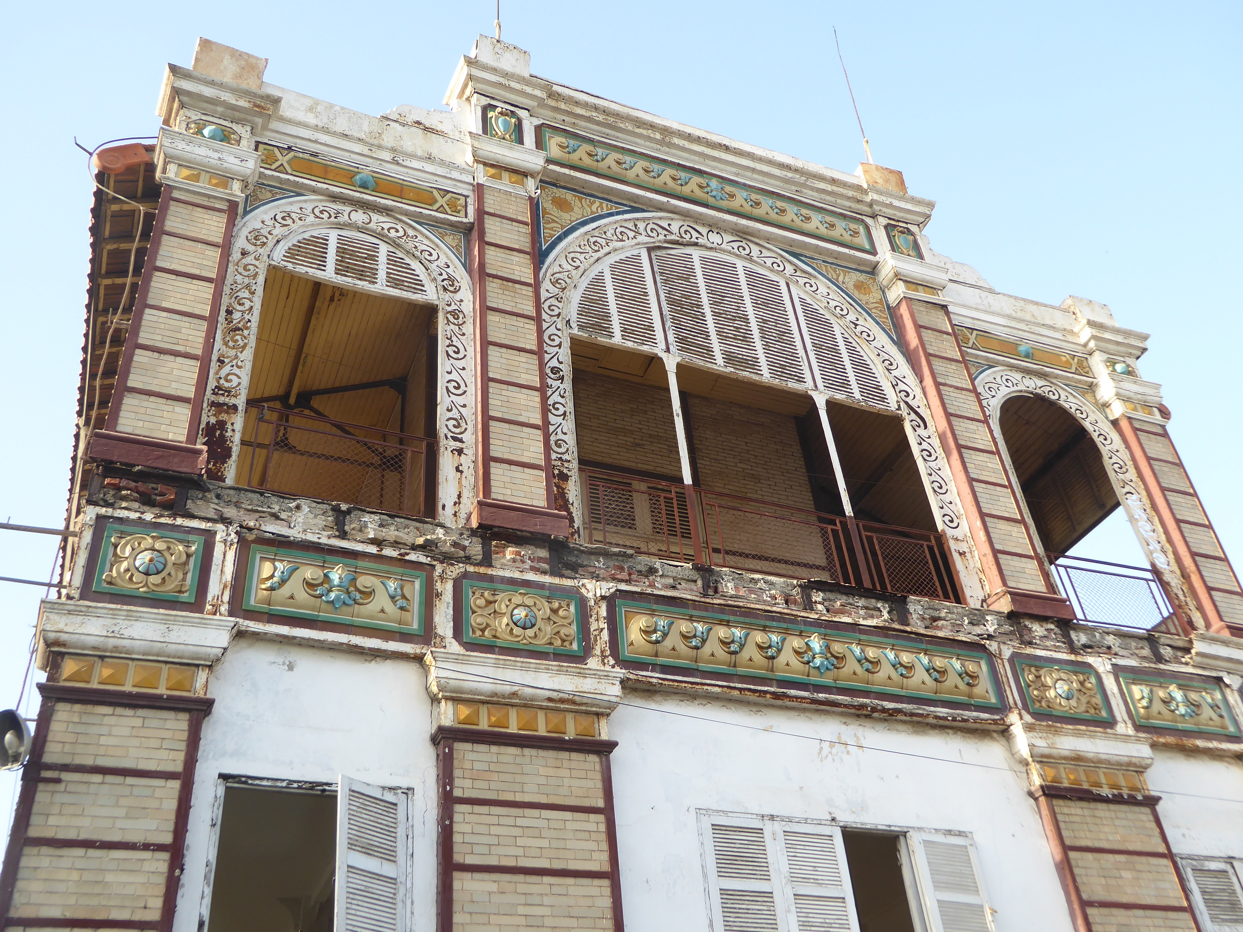 Iron frame, brick fill, faience trim. Still no ideas?