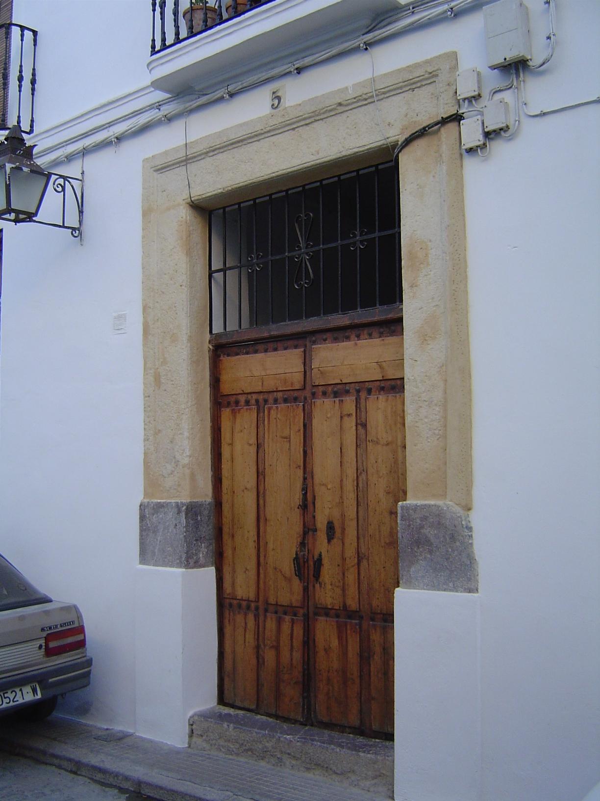 An odd doorway ornament, but really not so odd: the inverted "U" is modelled on the similar but far grander alfiz that surrounds the mihrab