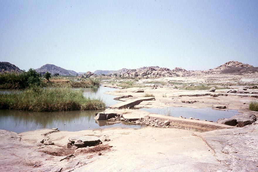 Here's a way to skip the well altogether: a crude dam blocks a river to divert its flow into a ditch. This is the headwork of one of the Vij