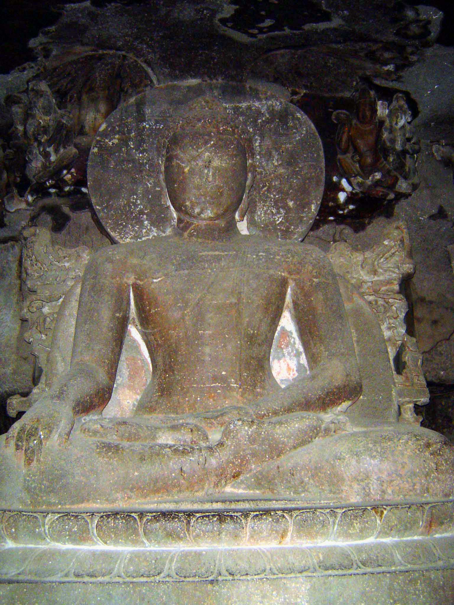 Here, from a different level of the same cave, an image of the Buddha in the famous bhumisparsha mudra, touching the earth to symbolize his