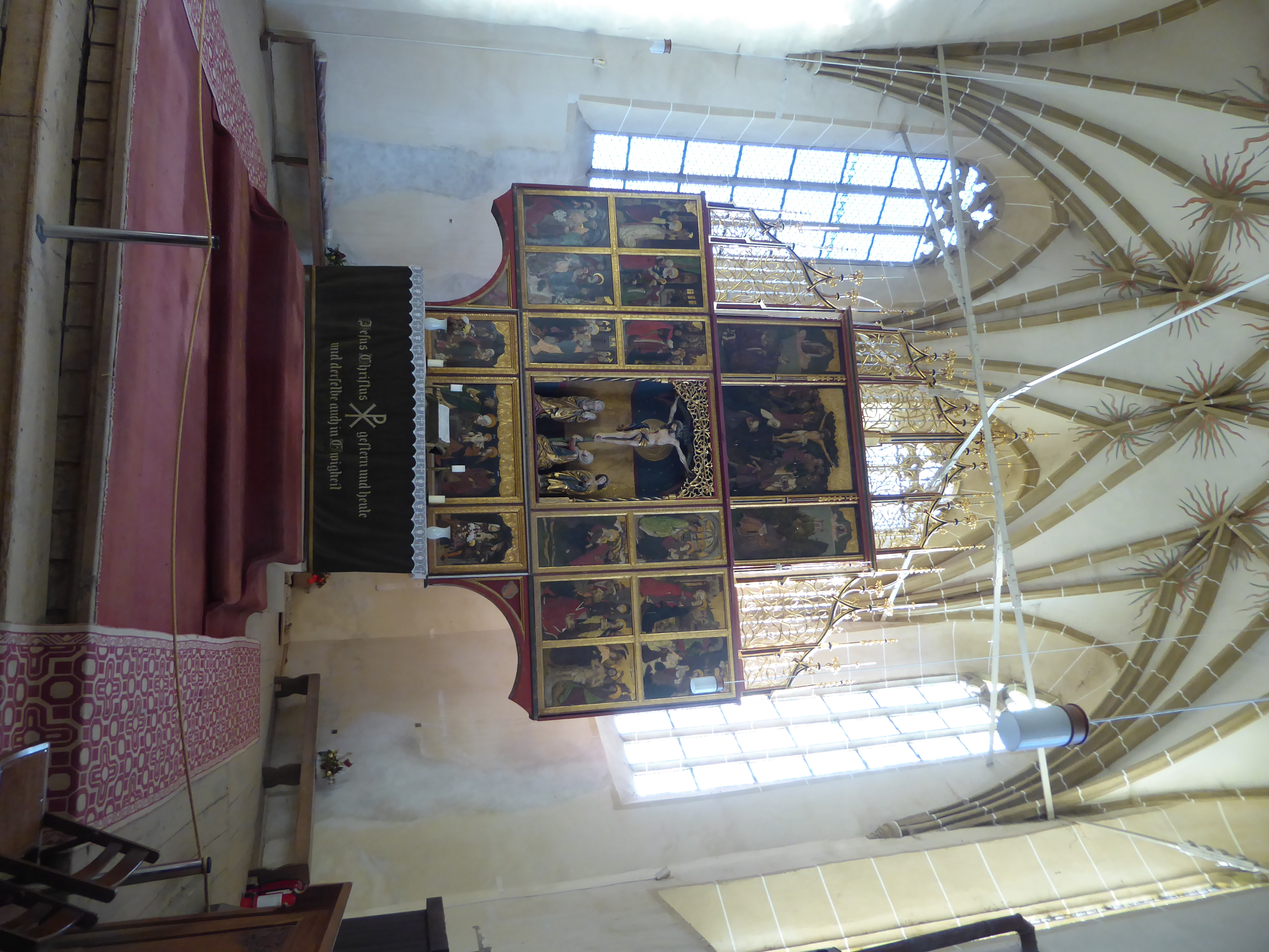 The exception is the golden altarpiece with panels illustrating the life of Mary. The web vaulting at this end gets a sprinkling of stars, t