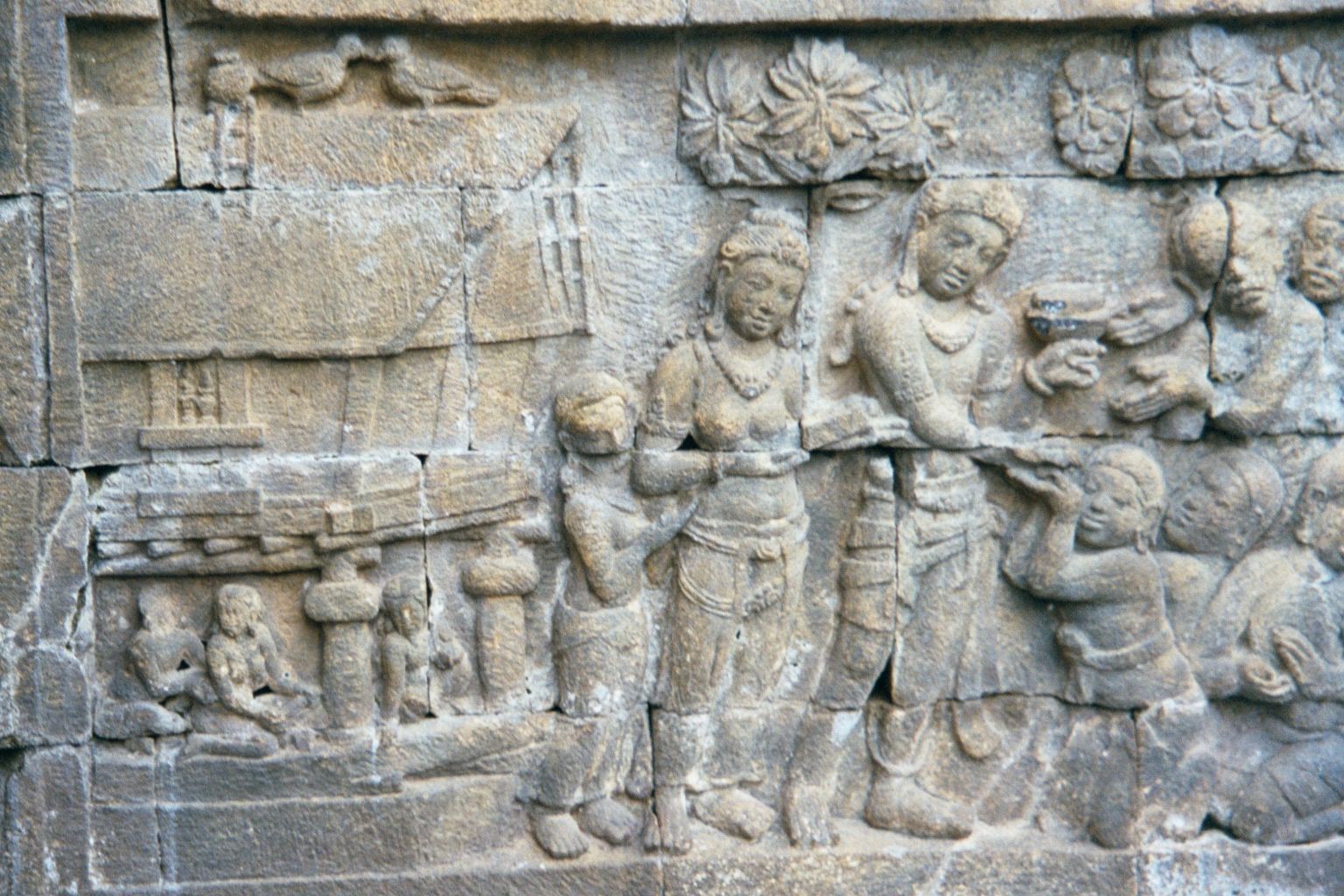A closer view of the scene, showing the welcome accorded Hiru, one of Rudrayana's ministers. The house, like the ship, is historically inter