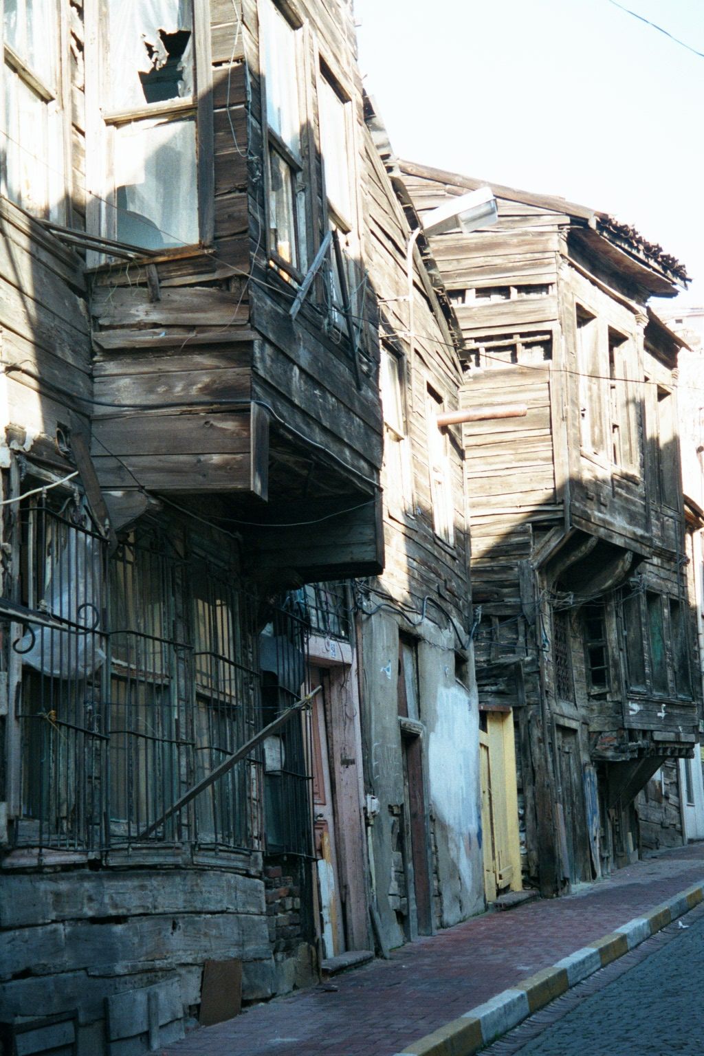 A nearby street, lined with the wooden buildings common in Istanbul. The tombstones are in considerably better shape.