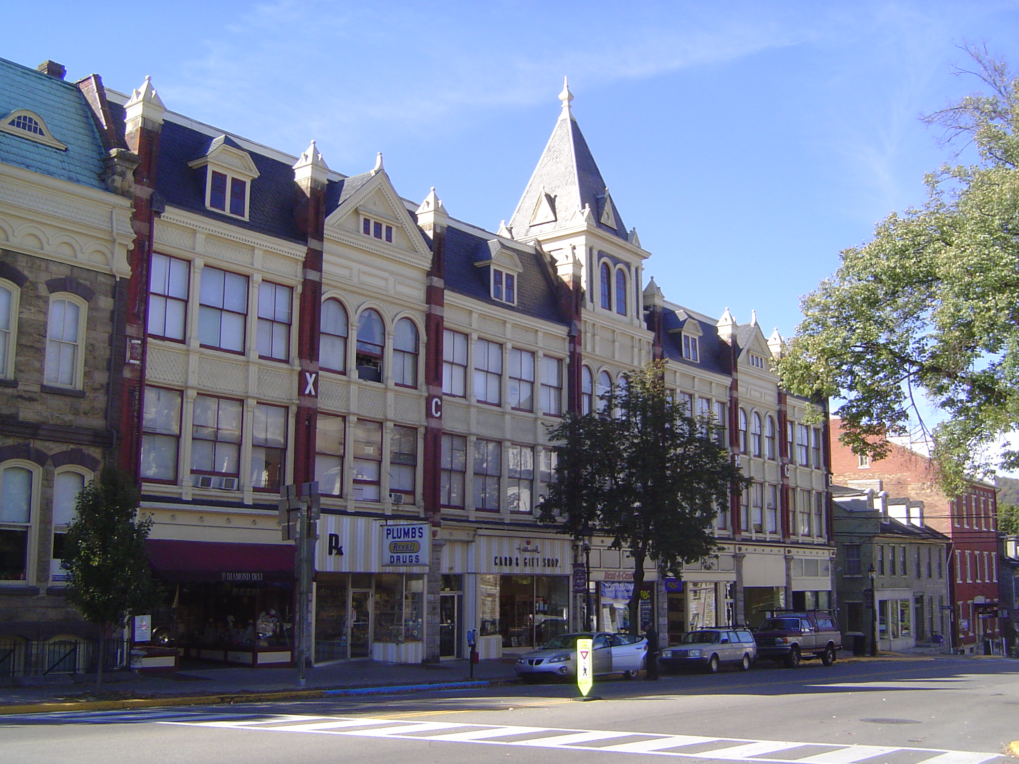 A block to the north, the Crider Exchange was built in 1889 with an iron frame, lots of windows, and fish-scale, pressed-metal sheets betwee
