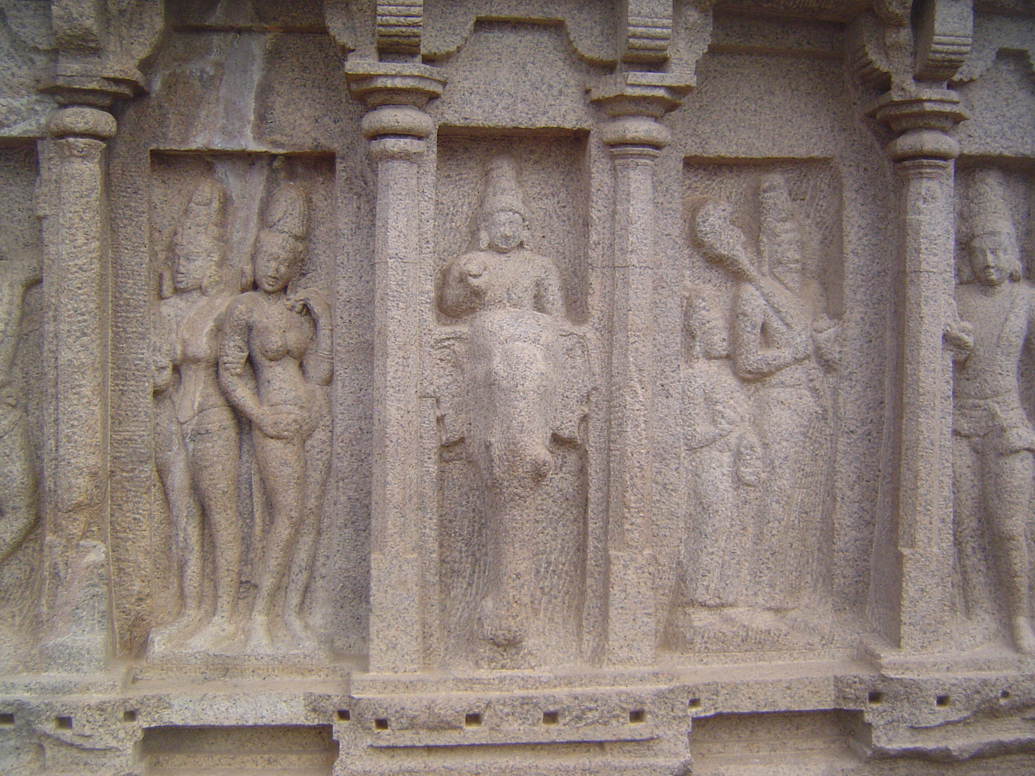 Some say that he is instead Subrahmanya, the god of war and victory. Two royal ladies are to his left; to the right are a sage and disciple.