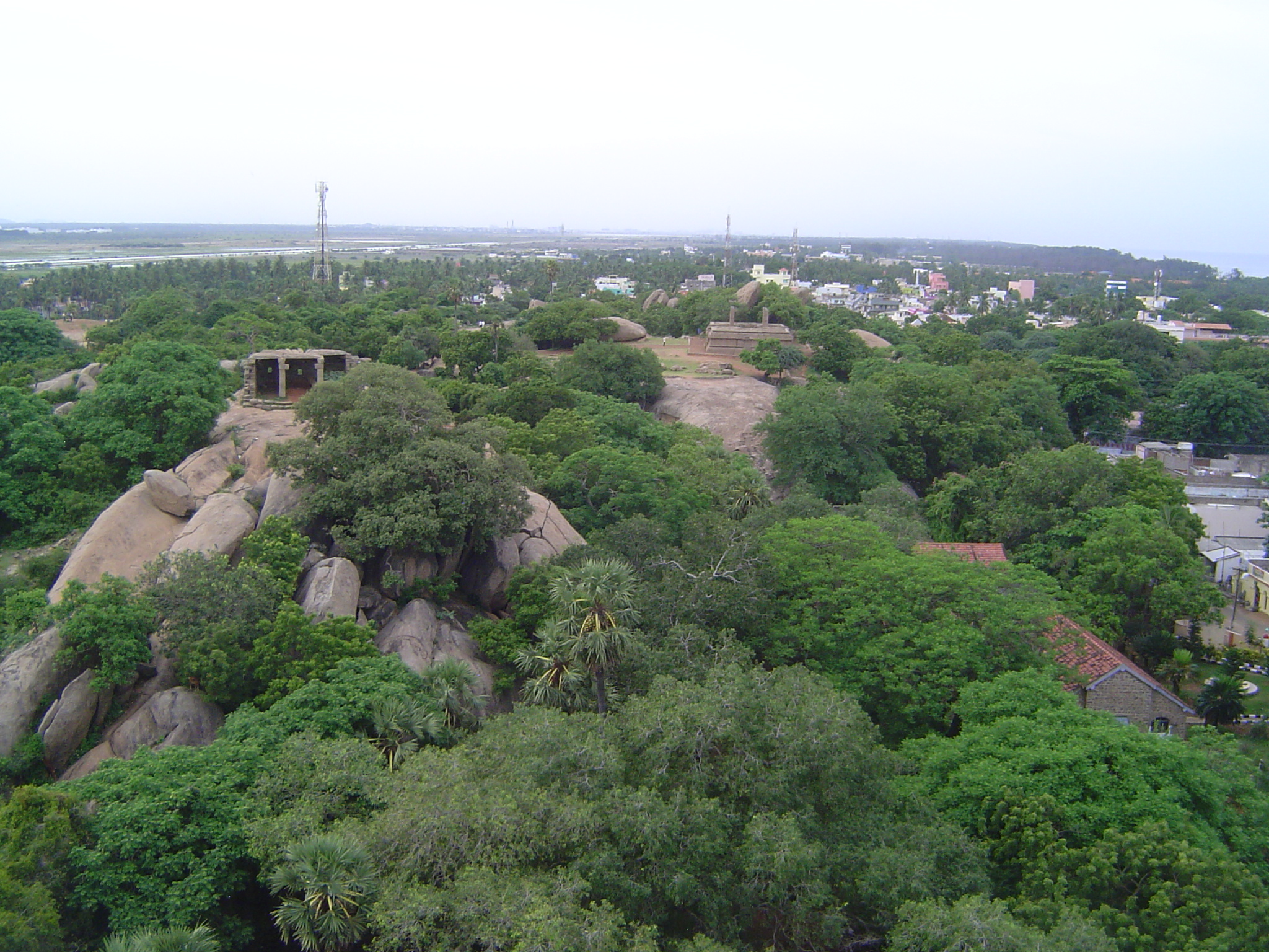 The sea is perhaps a quarter mile to the east. About ten monolithic temples have been scooped from the rocky ridge. The modern town of Mamal
