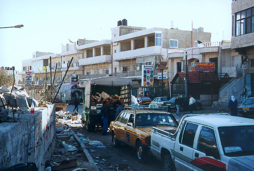 The main junction in Abu Dis, where roads and bus lines converge in a commercial center grievously untended.