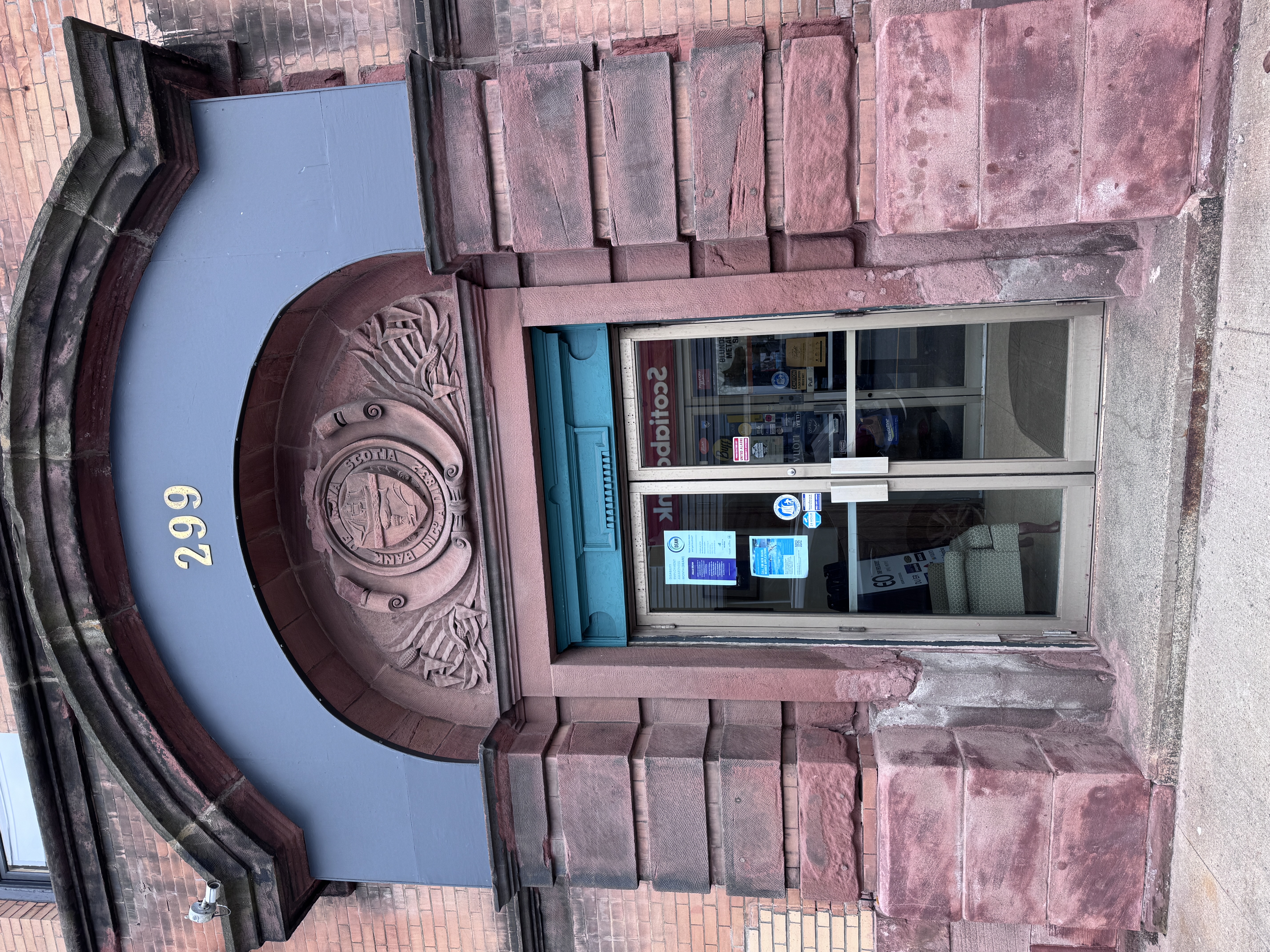 The words in the tympanum read Bank of Nova Scotia.  The building is close to the former offices of Western Union, which had a cable running