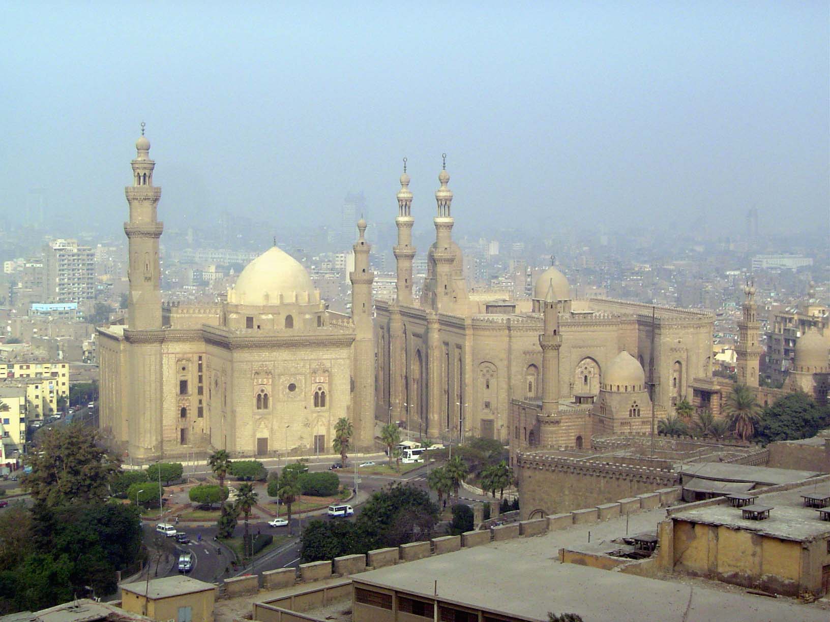 Nos. 133 and U103 We're at the edge of the citadel, looking west over its high wall to two buildings. The one on the left is the Madrasa of