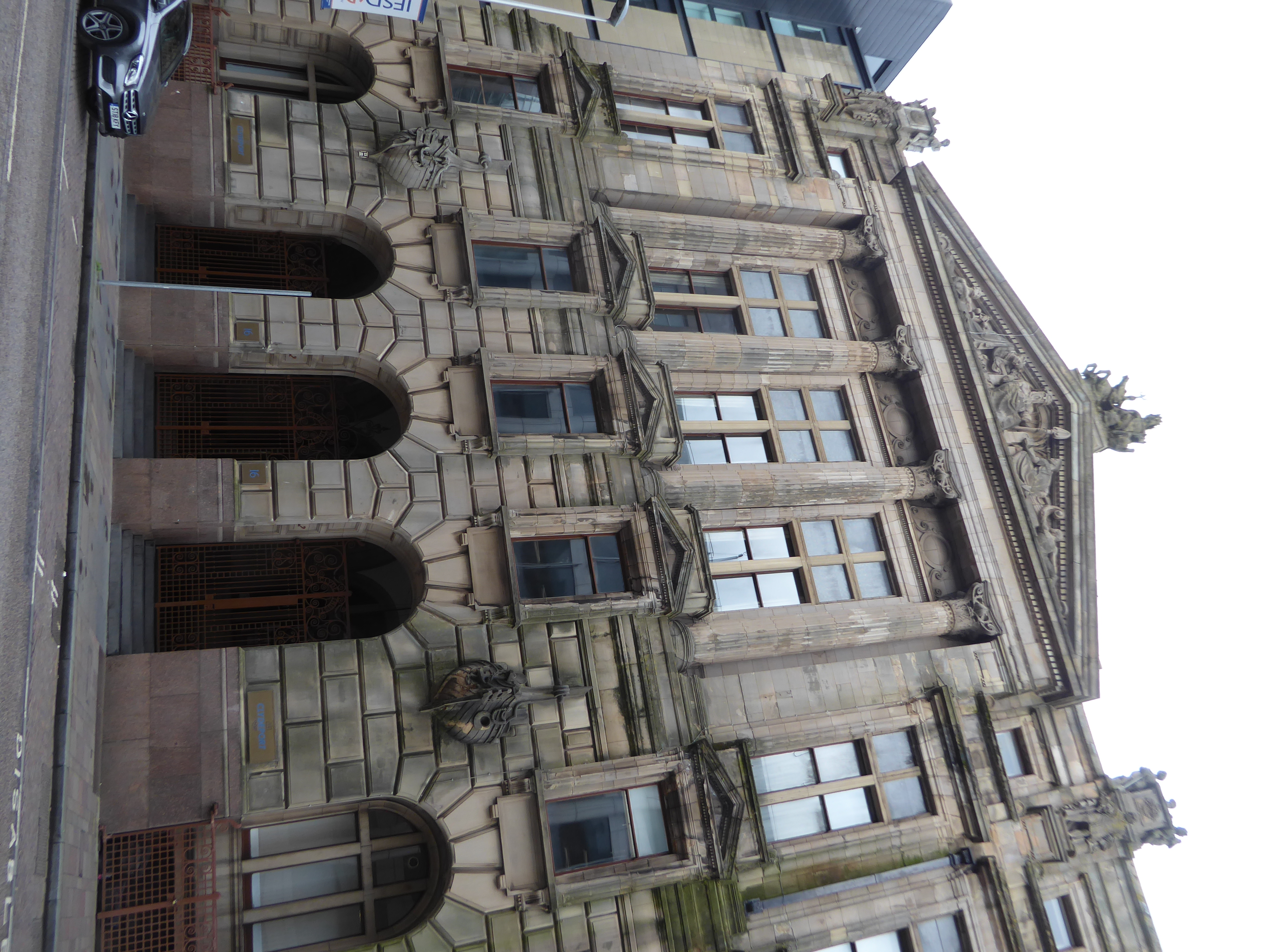 Here's the older part of the same building, with plenty of symbolism in the shiplapped prows bursting through the walls. Neptune and seahors