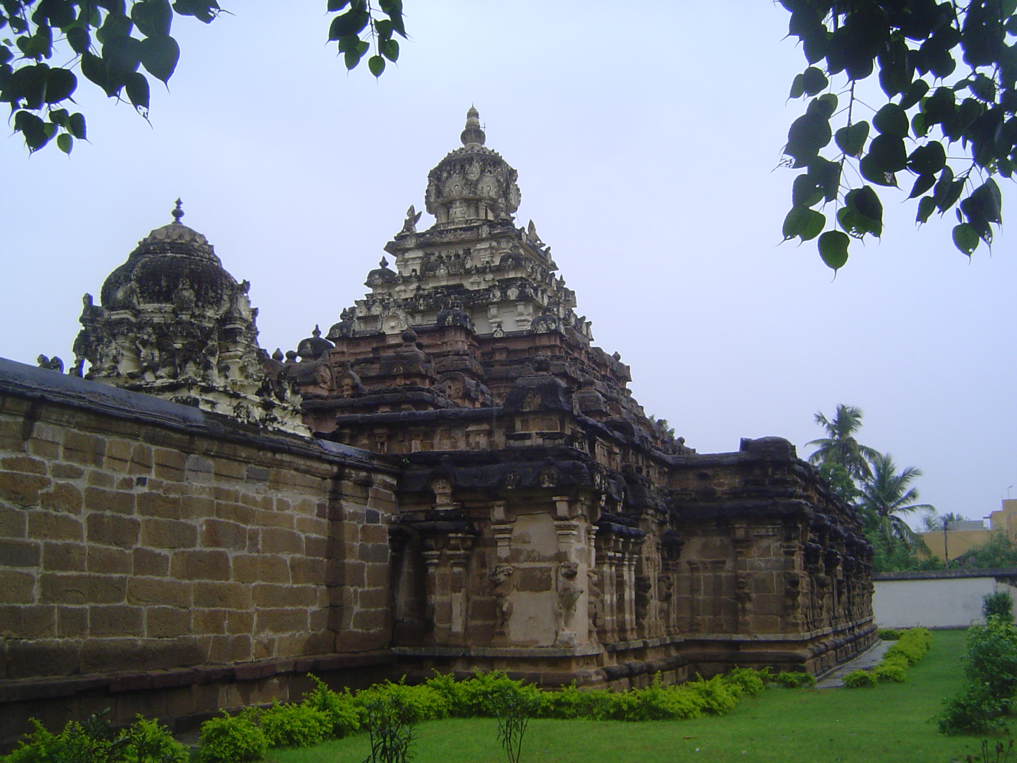 Step to the side and you see the temple's original wall, which encloses an unusually high vimana, literally a "palace" but figuratively a sh