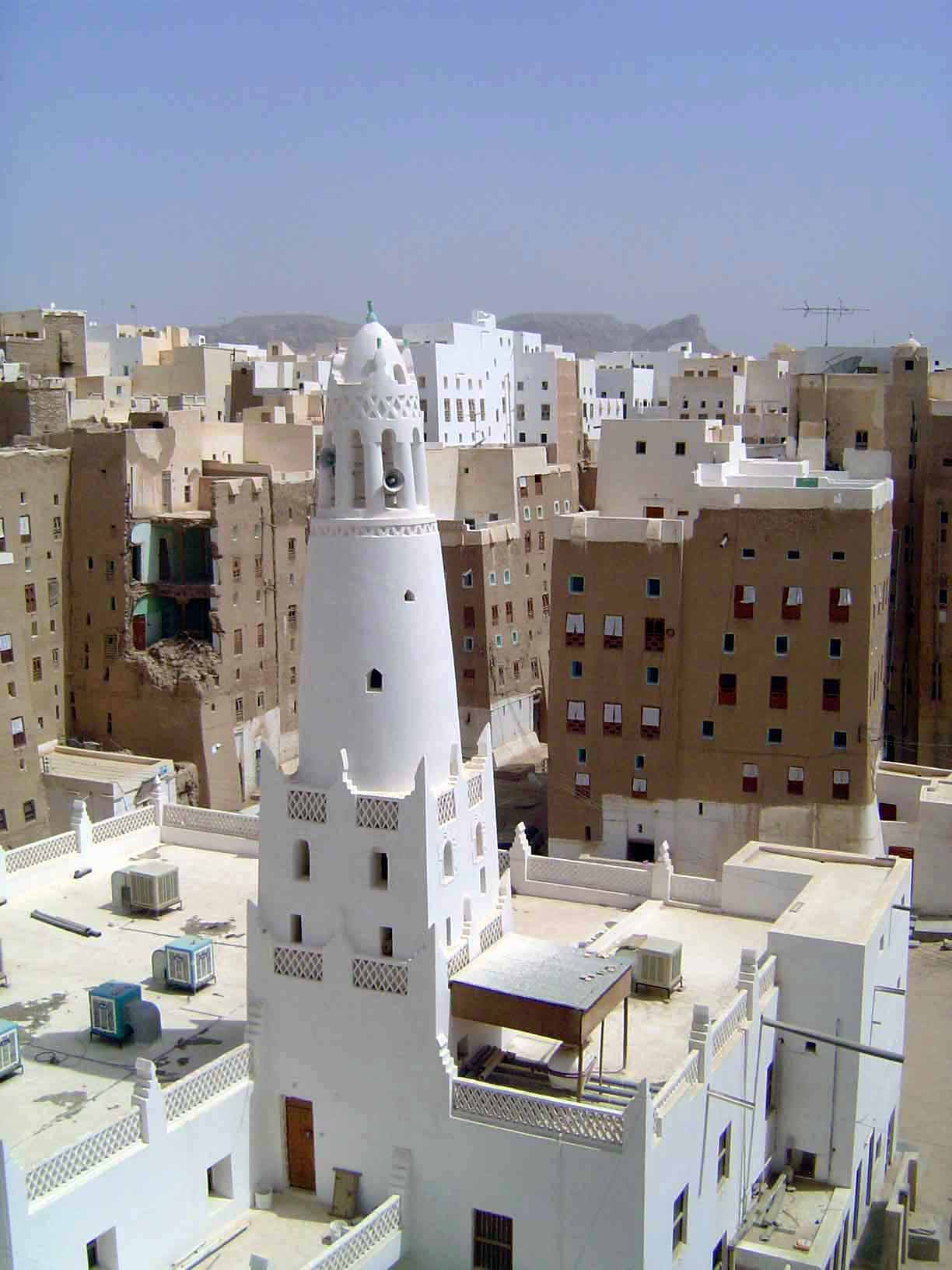 The view from the roof of the palace and over the minaret of the Masjid Maruf. The bands of a contrasting color at the top and base of many