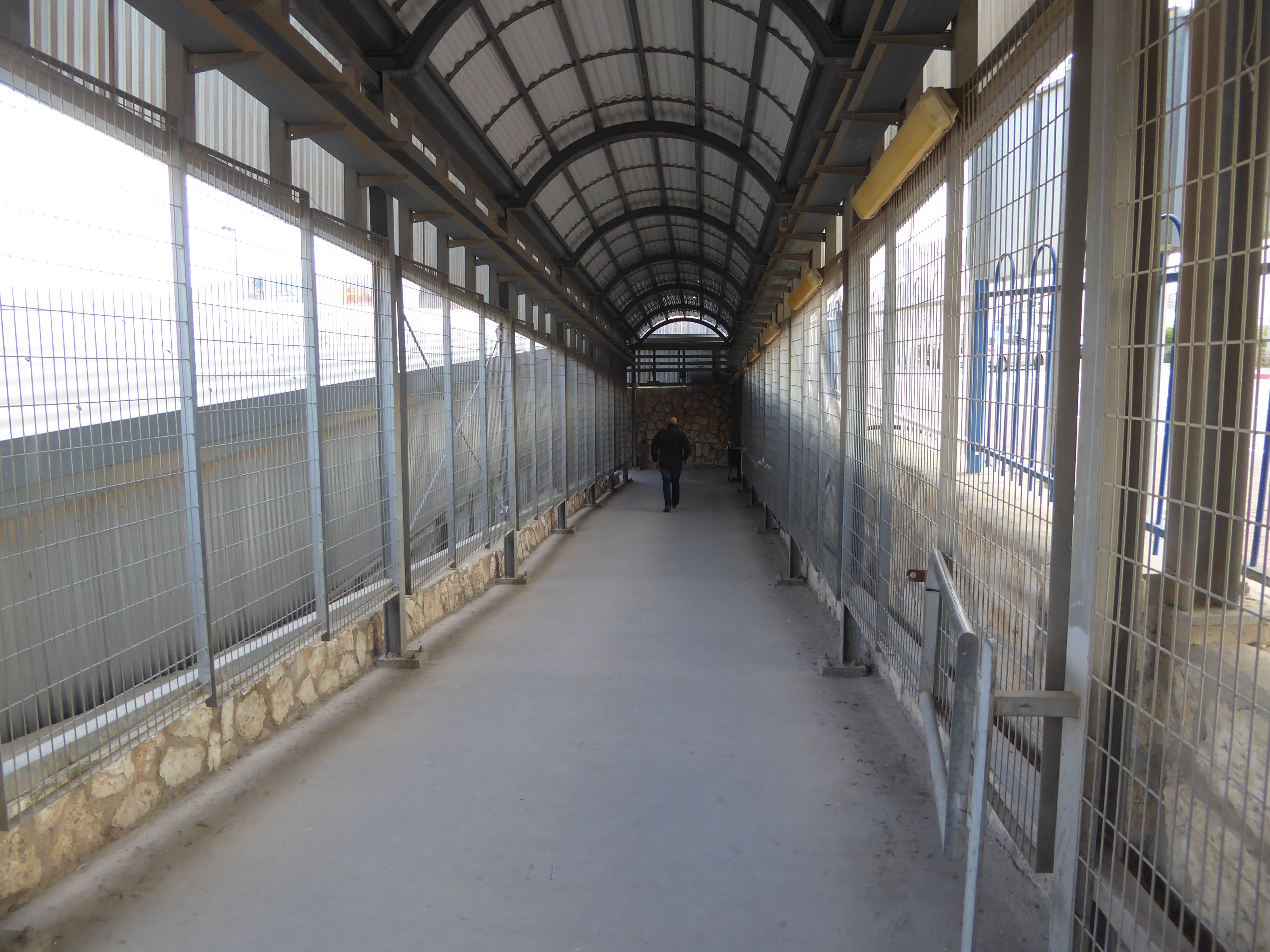 Pedestrians coming into Israel pass this way, with turnstiles ahead and document checks.