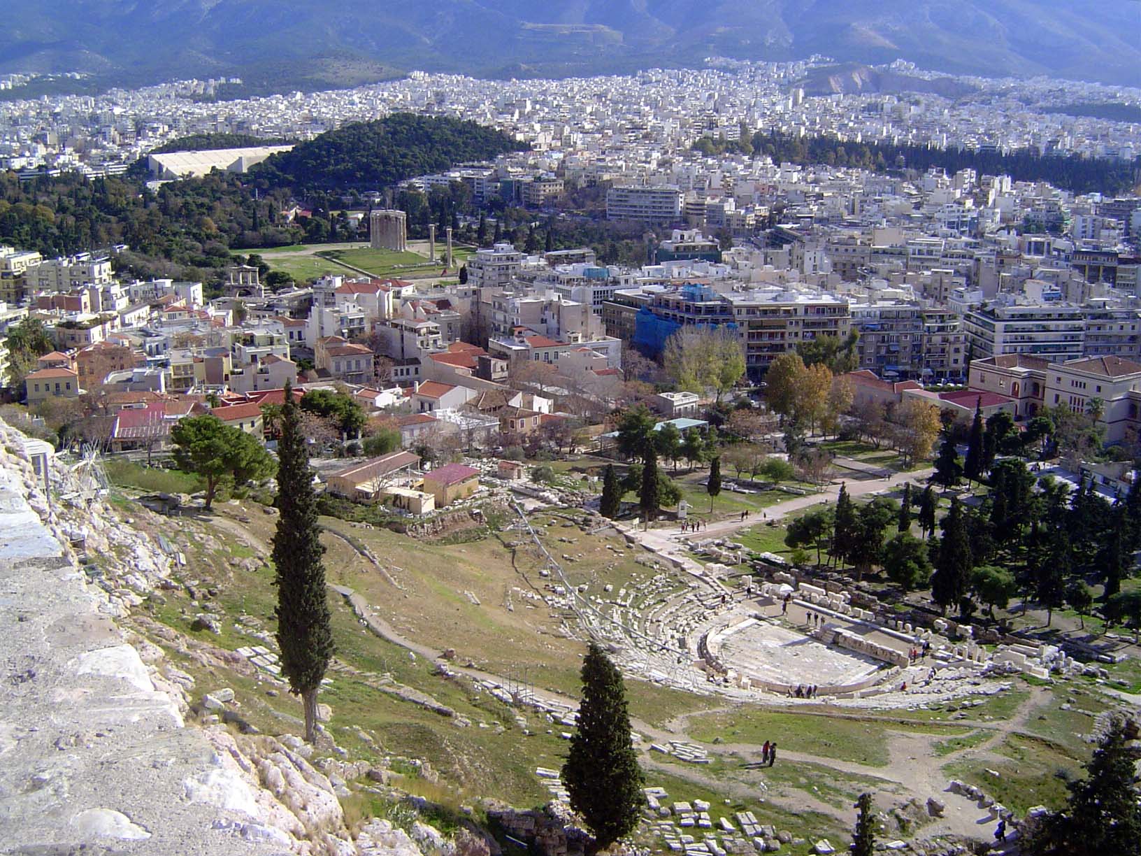 Looking down from the Acropolis to the remains of the Theater of Dionysus, where plays by Sophocles premiered. In the distance just before t