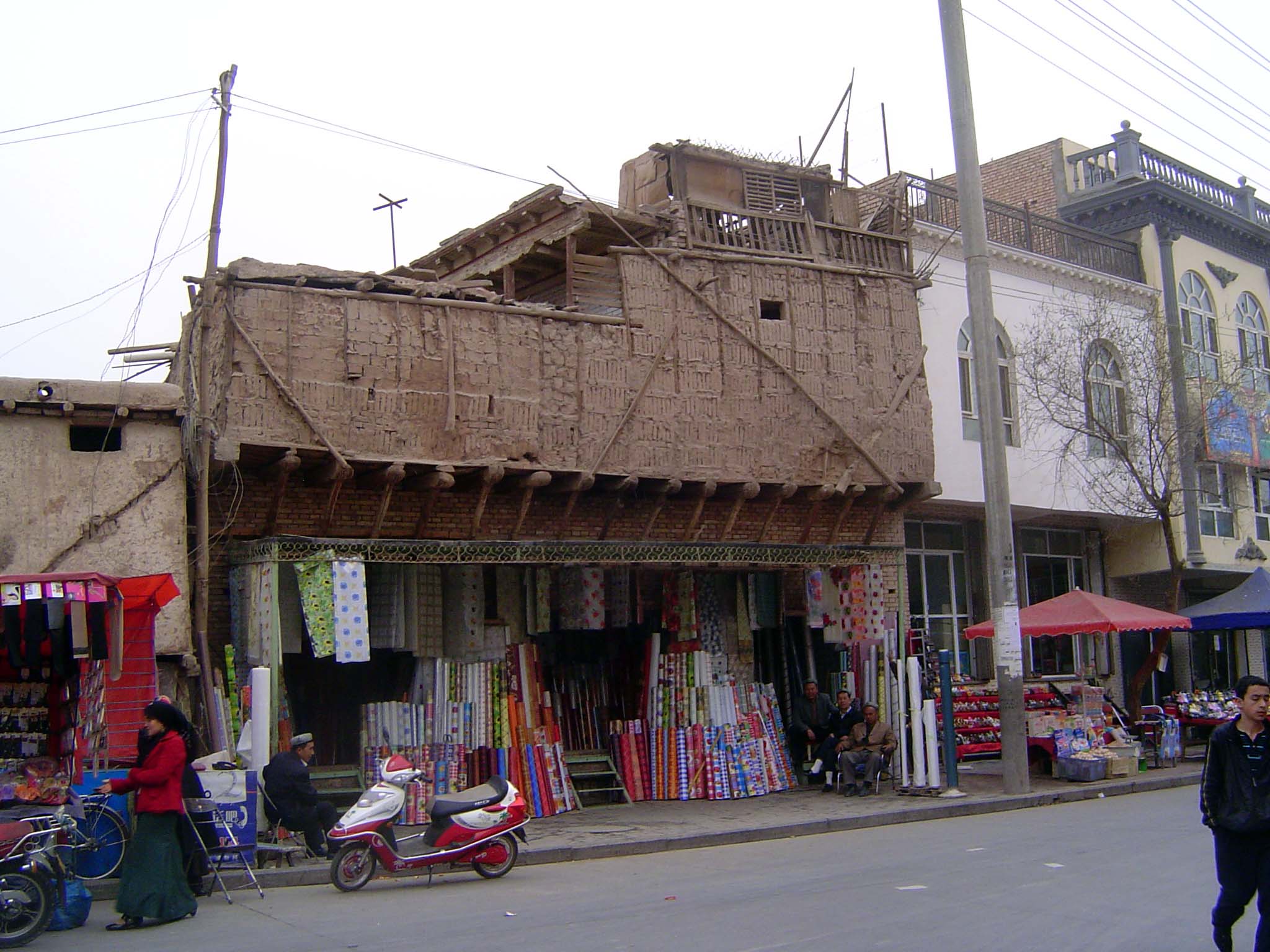 Simple construction with wood frame and mud-brick infill.