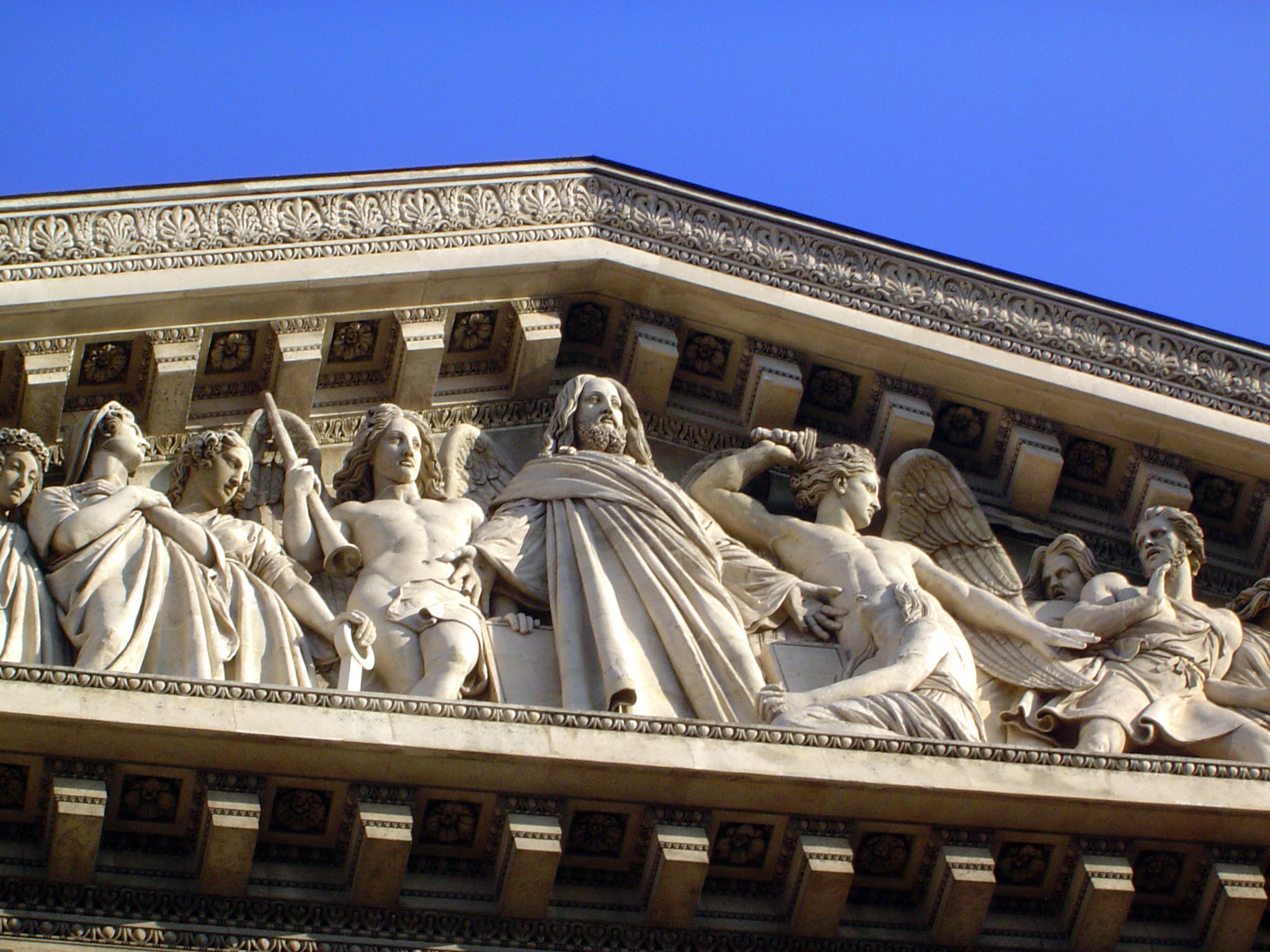 The pediment sculpture, by Philippe Lemaire, shows the Last Judgment. A St. Michael who hasn't been trained to play well with others begins