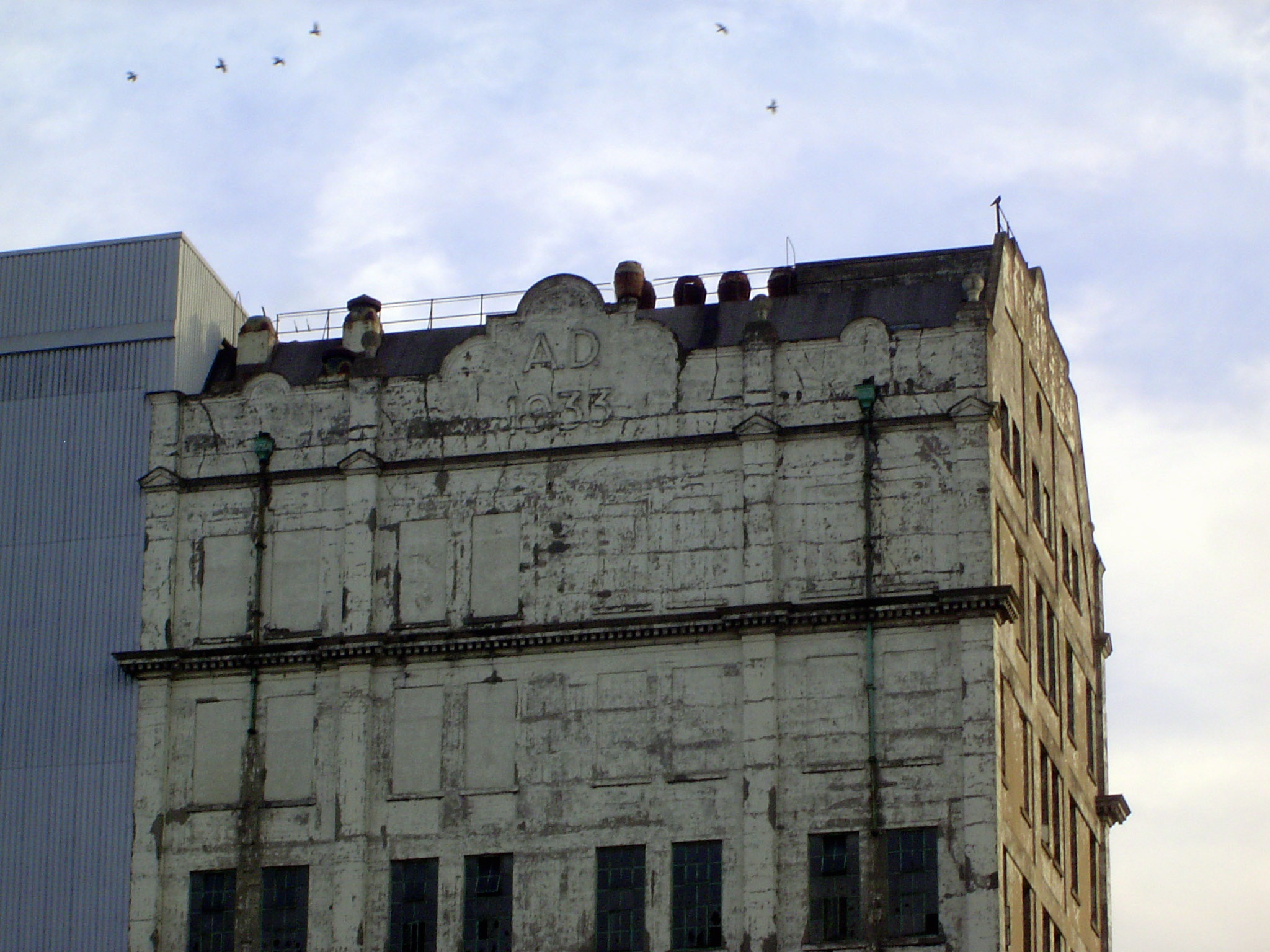 A gabled wing of a secondary building of the Millennium Mills. The date is 1933.