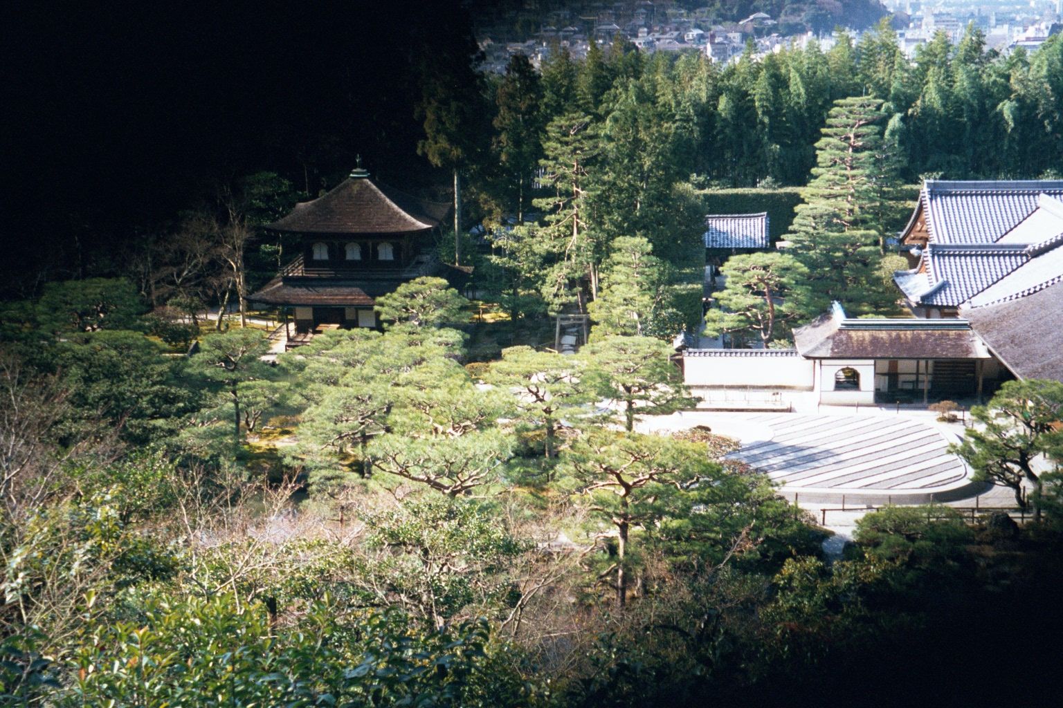 You can see the line of the hedges behind that white signboard. In the left-center, the Silver Pavilion, behind the Brocade Mirror Pond. On