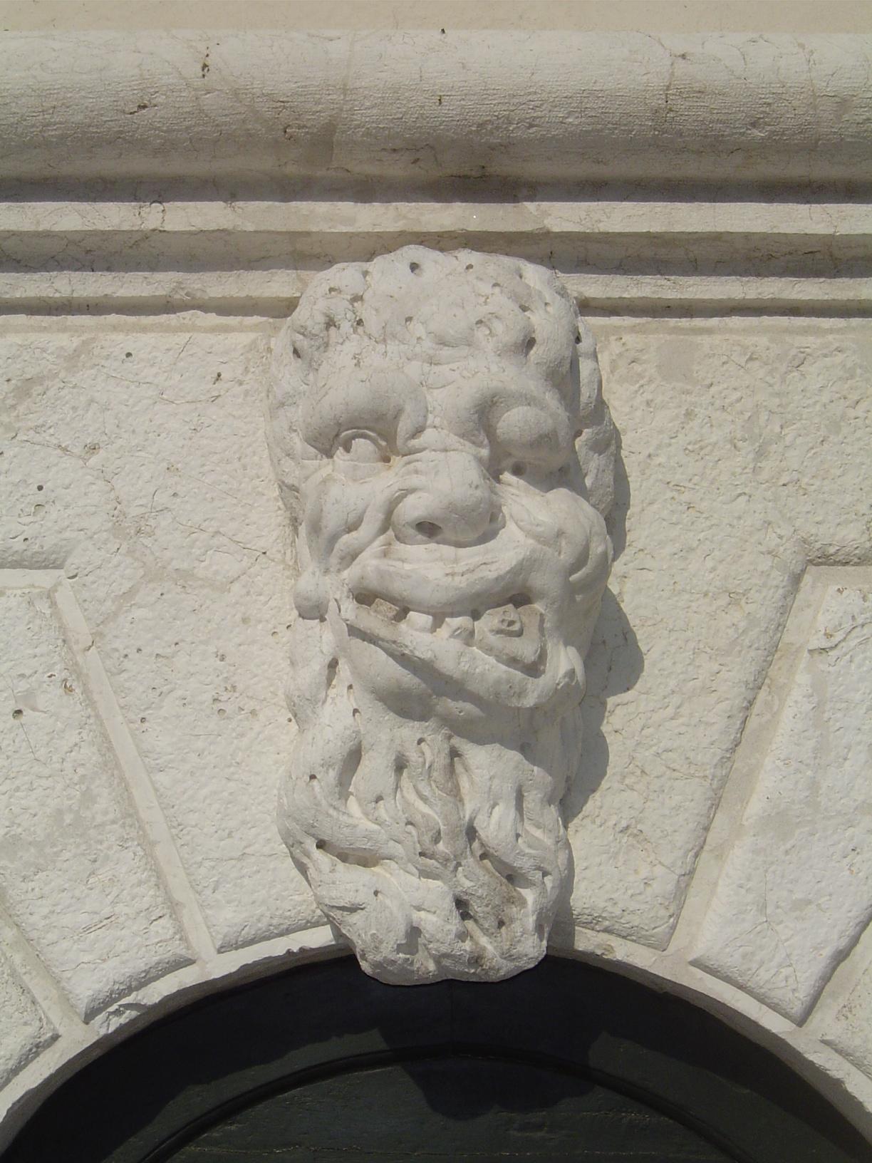 Here it is, and here is what Ruskin says of it: "A head,—huge, inhuman, and monstrous,—learing in bestial degradation, too foul to be either