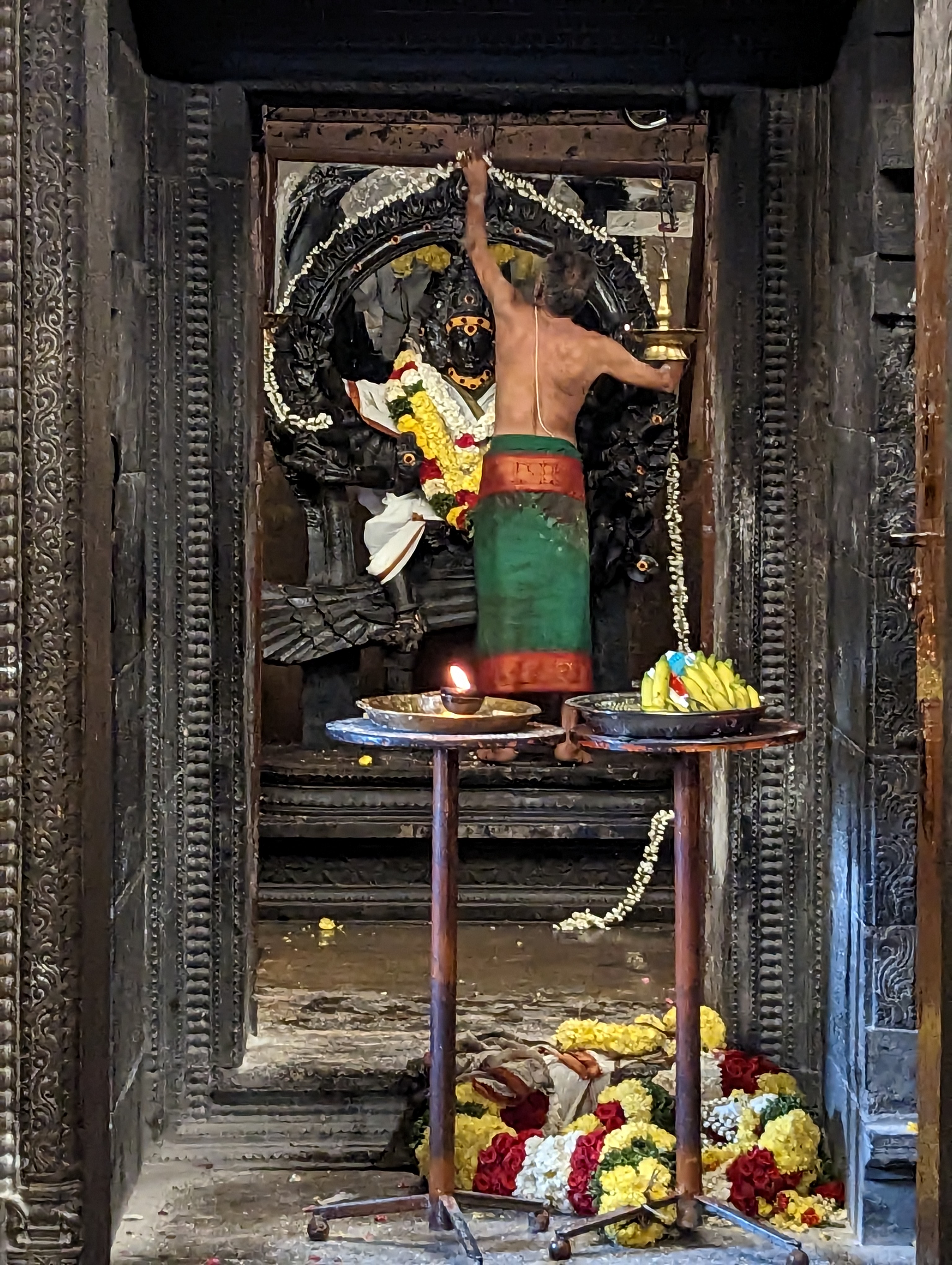 A priest cares for the image of Subrahmanya, a son of Shiva.