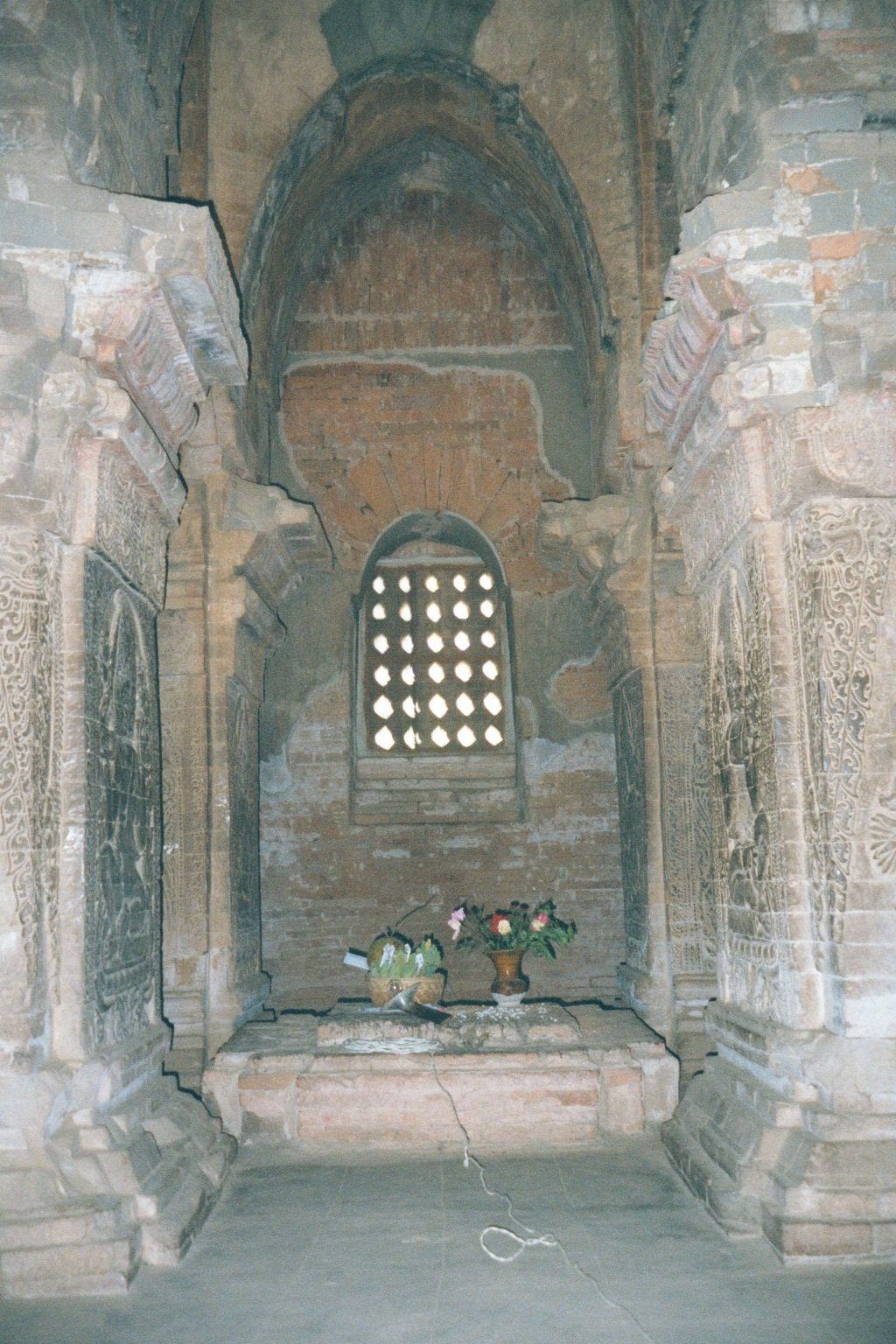 Inside, the dark shrine is a cubic room almost filled with four massive piers. They're too big simply to support the roof and tower. Instead