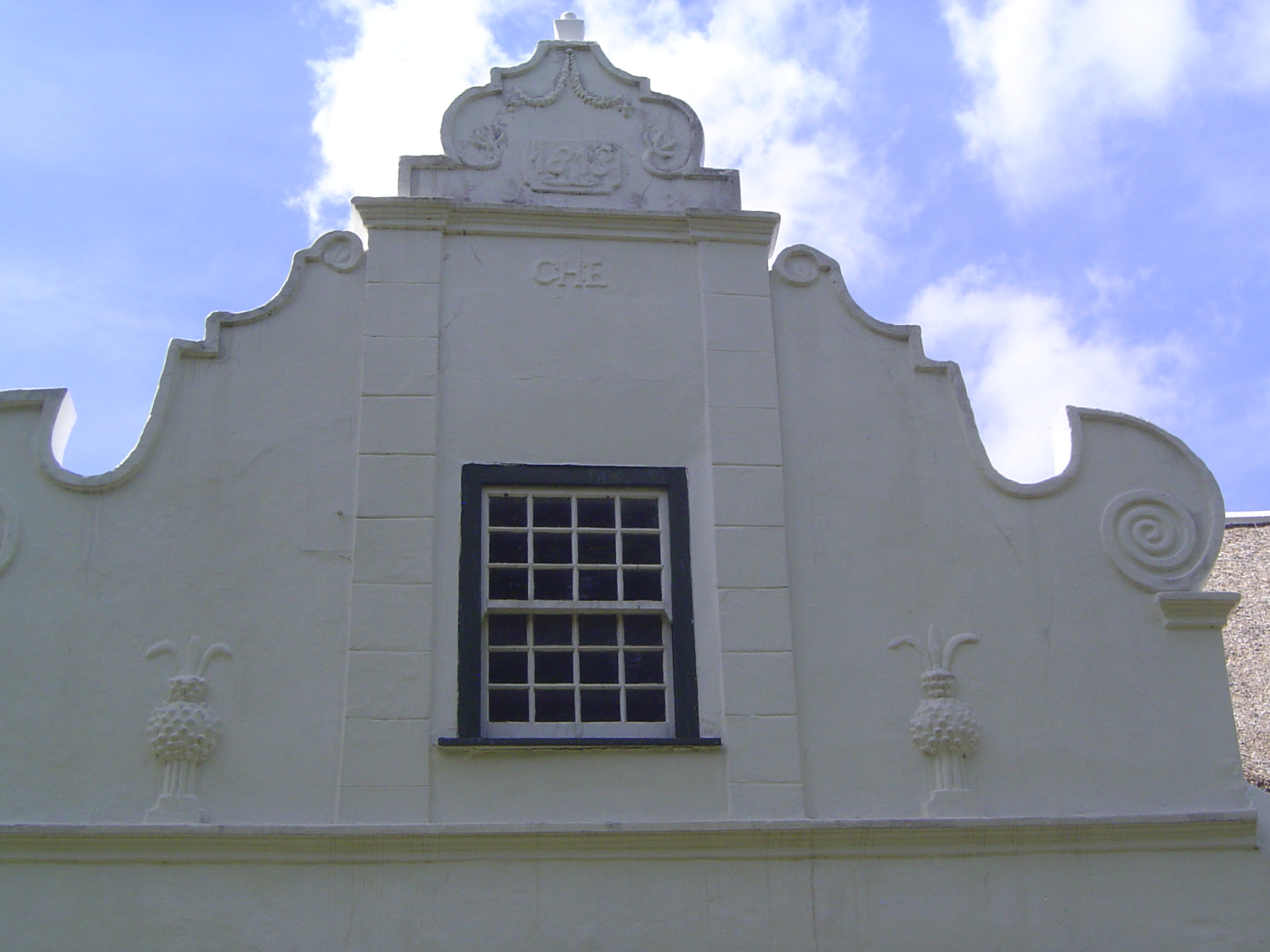 It took almost a century before the church had a town around it. Here's the roller-coaster gable on a nearby house on De Jongh Lane.