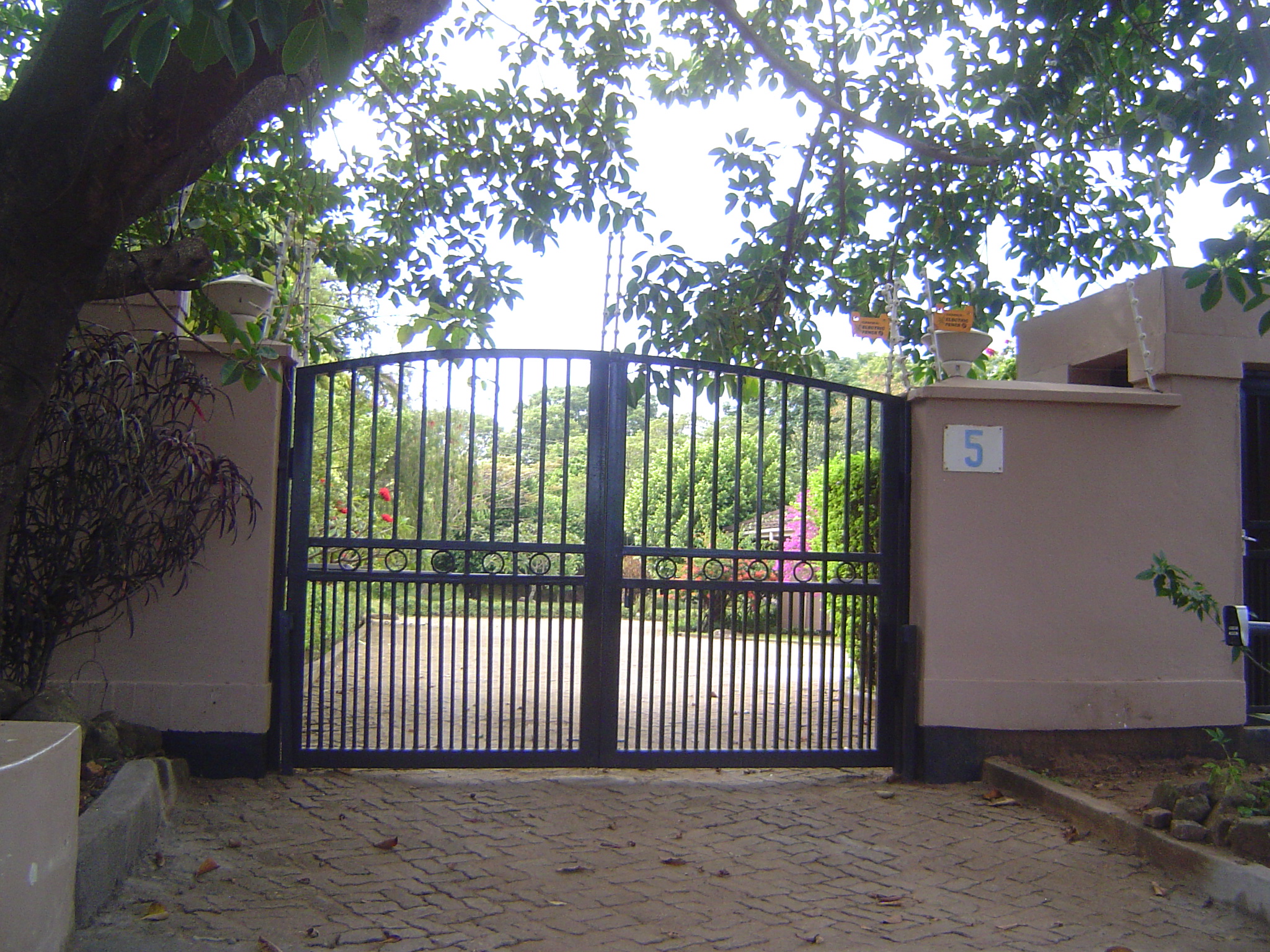 The wall and gates are topped by delicate electric fencing on the South African model.