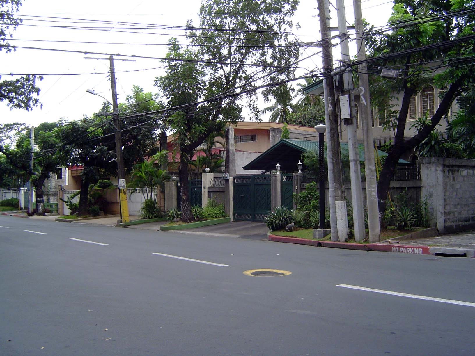 Flanking the center is a gated community. Manila has many. This one is San Lorenzo Village, a relatively modest refuge from the central city