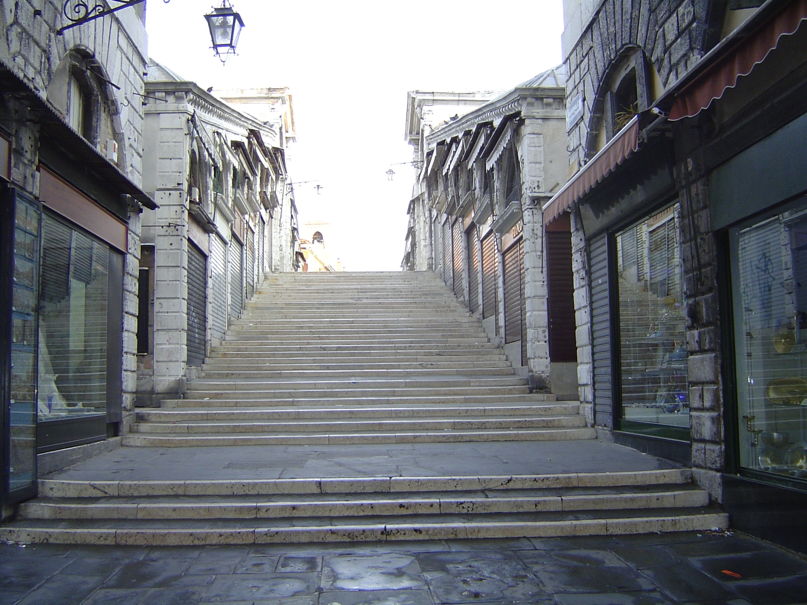 Like Florence's old bridge across the Arno, this one is lined with shop space, in this case rented out since 1591. Steps obscure the arch be