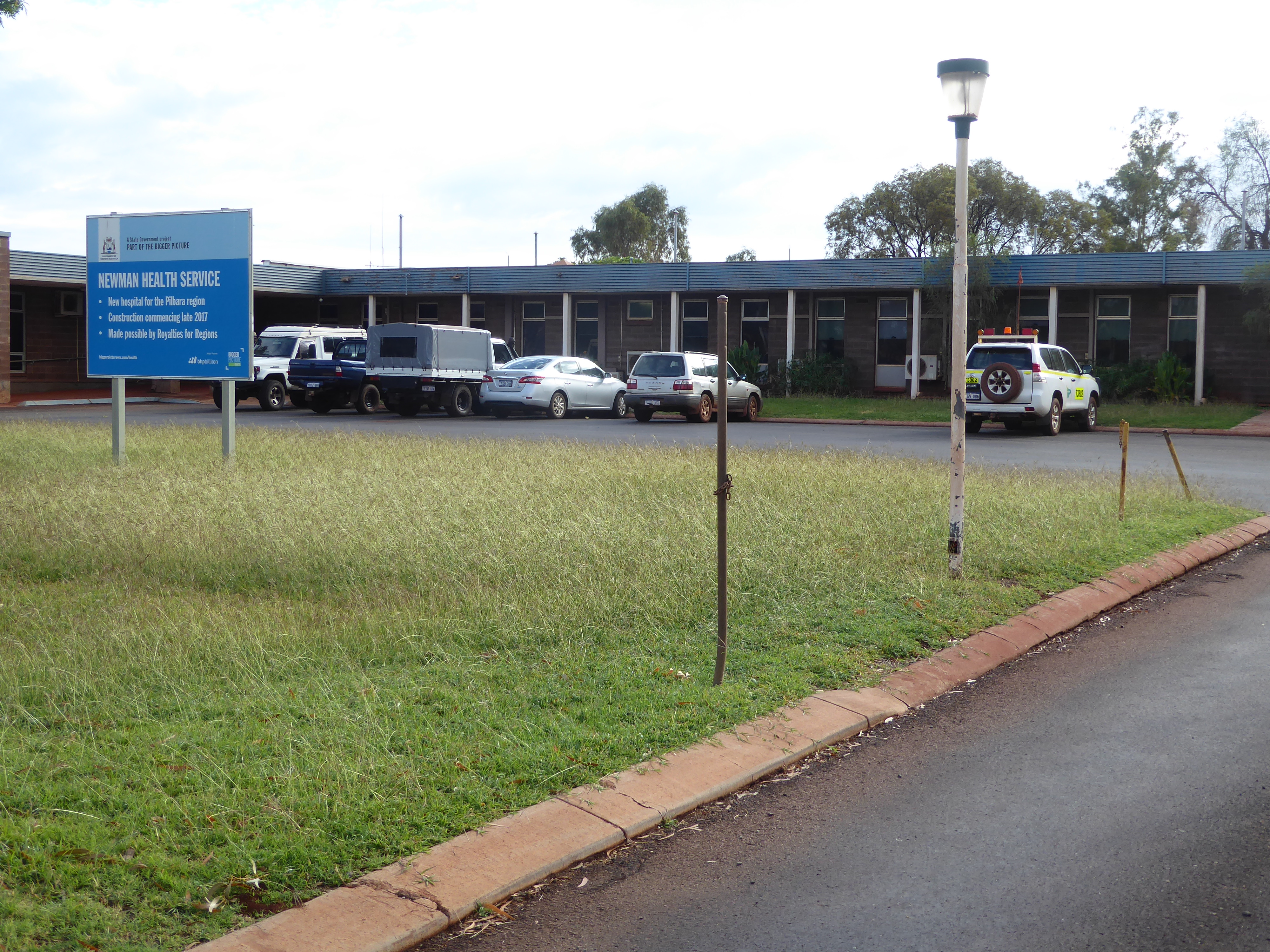 The sign announces that a new hospital is to be begun late in 2017.