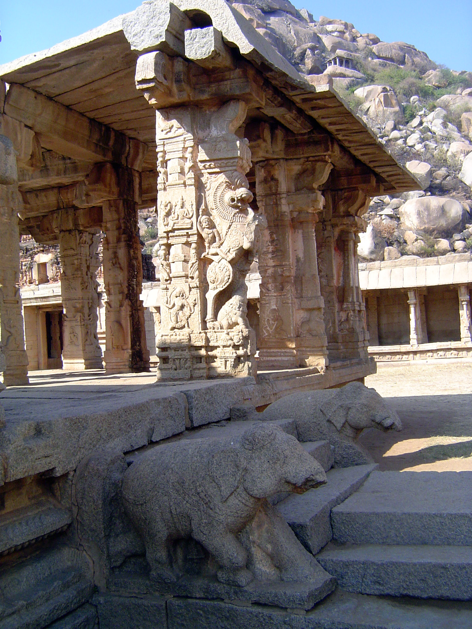 A half-lion, half-horse yali. He is mounted and leaps over a tiny kneeling elephant.