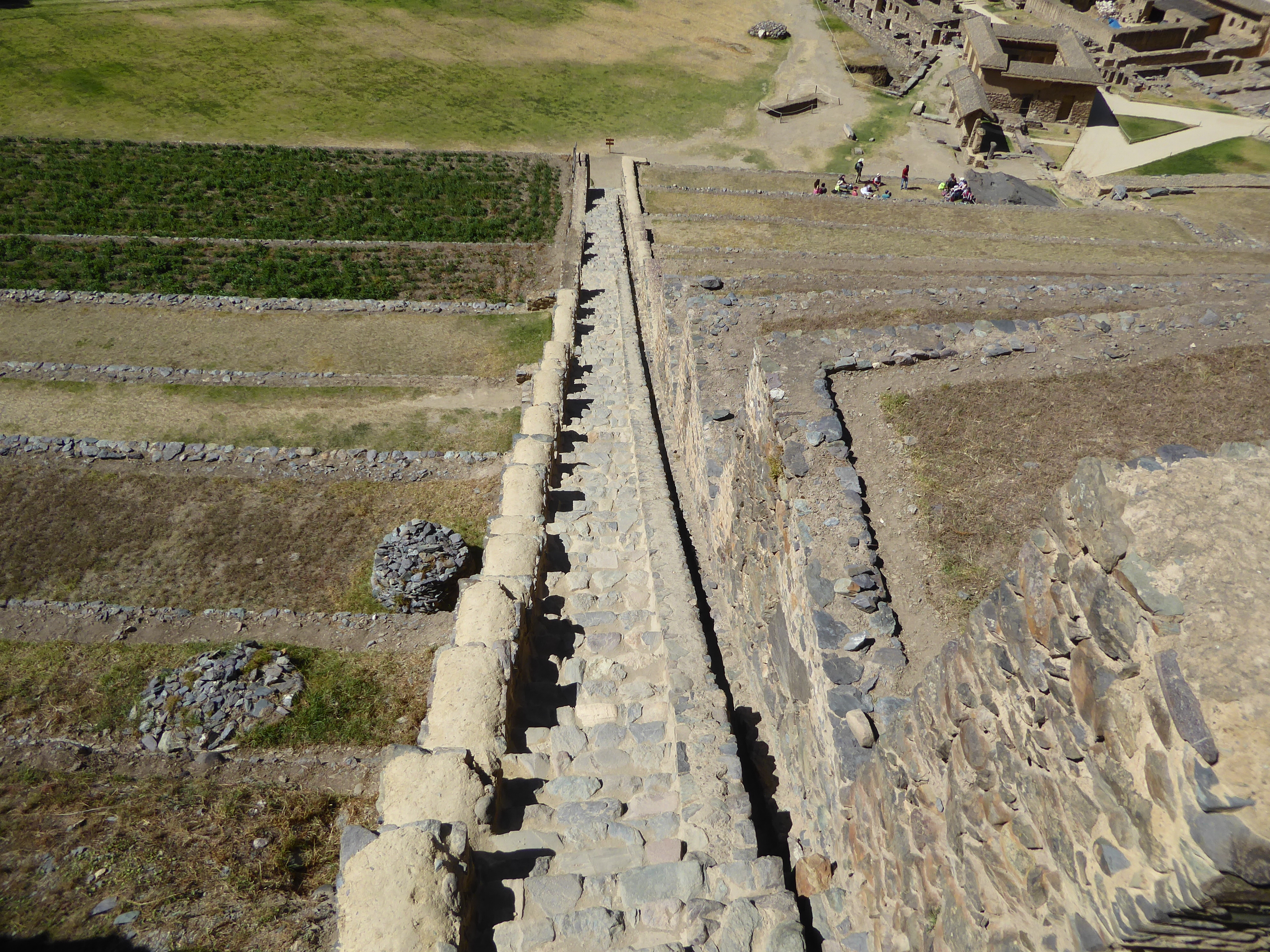We're up top of this second set of terraces and looking down not only a staircase but an irrigation channel.