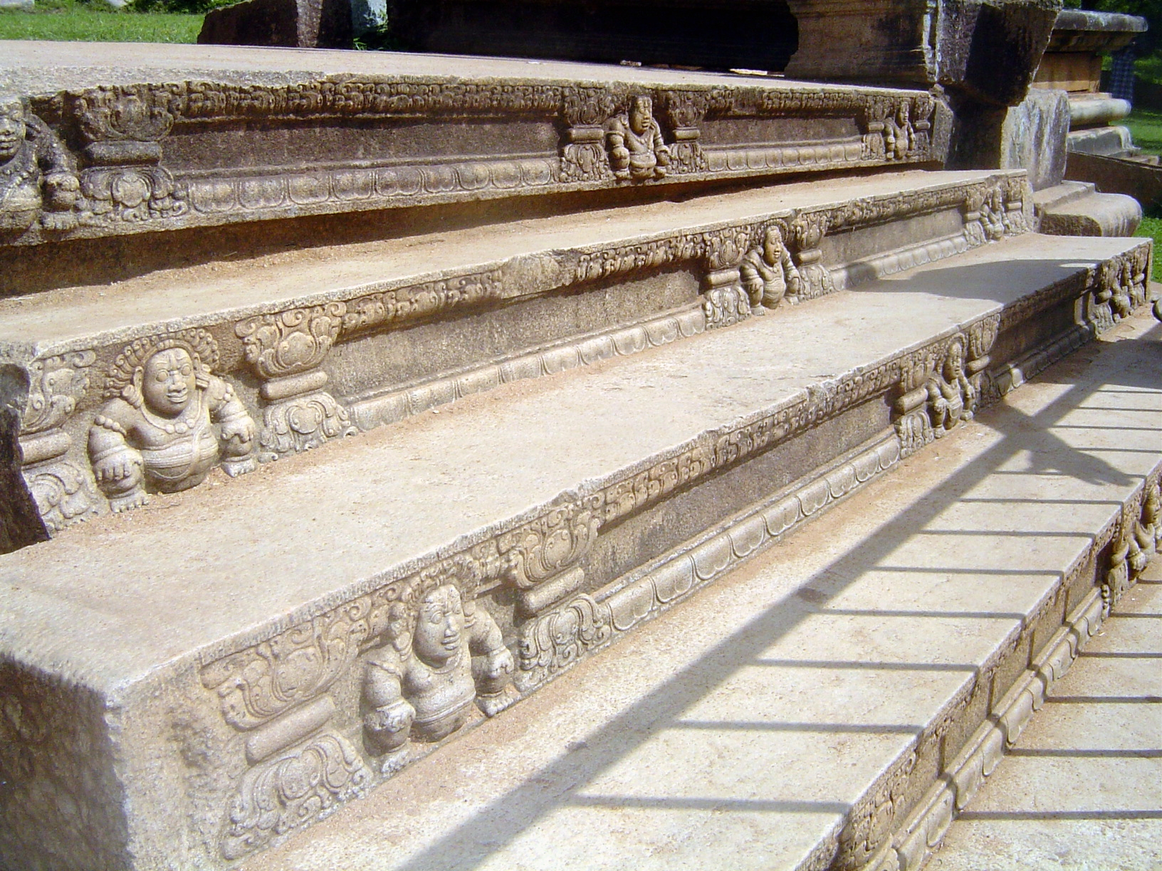 The steps are said to represent stages of purification. The supporting dwarfs are similar to those at Sanchi Peninsular India and many other