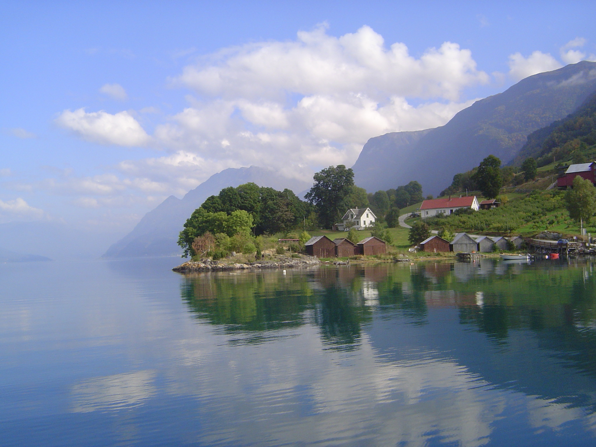 The hamlet of Urnes lies on the east bank. Boathouses hint at the fjord's historic role as a highway; now, though the small car ferry we're