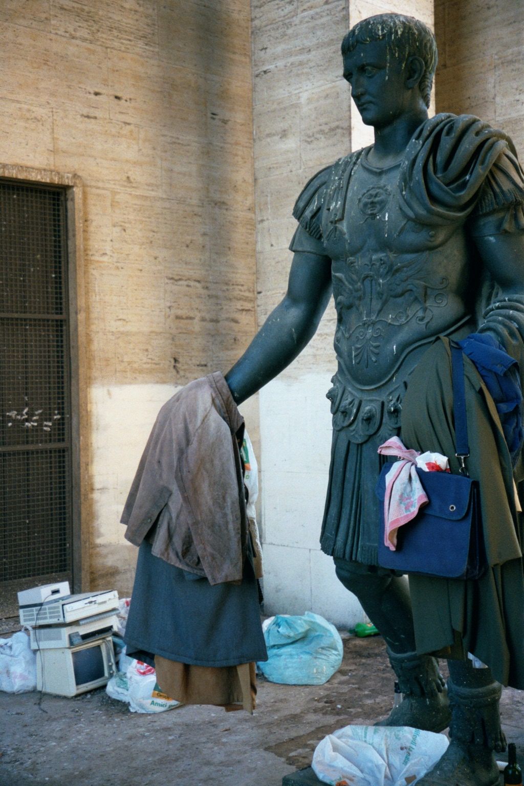 In a corner, Augustus Vendor is reduced to selling used clothes and computer bits.