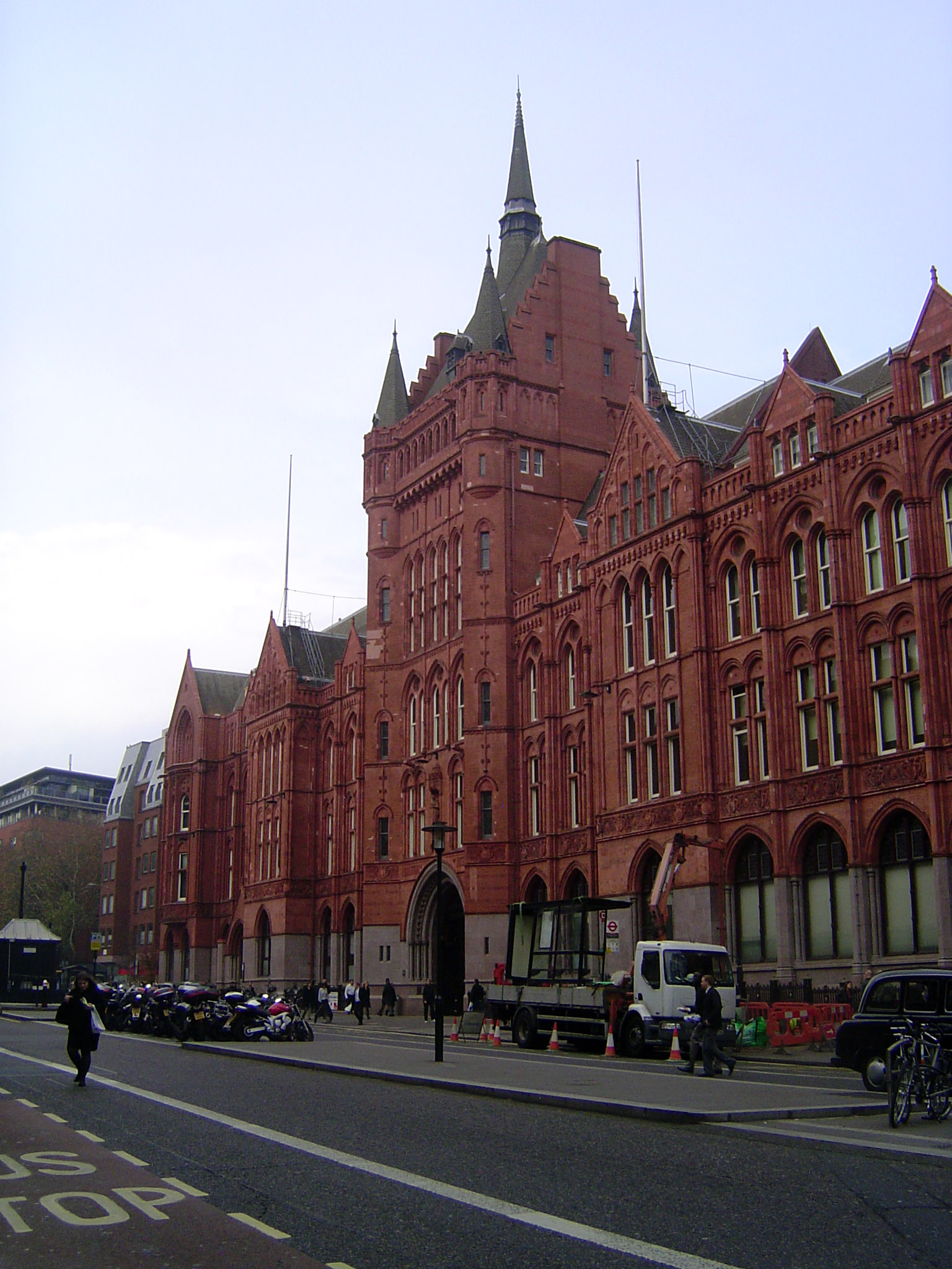Another view. Pevsner writes of the "long symmetrical facade of fiery red brick and red terracotta, amply gabled, and with a big central win