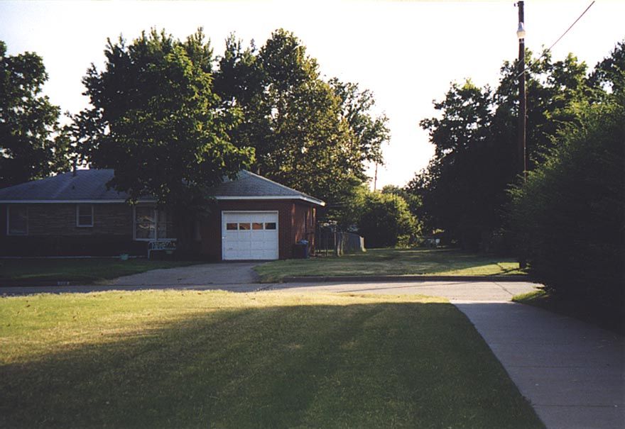 Standing in the access path and looking back to the street and the access path to the park in the adjacent block. An elementary school sits