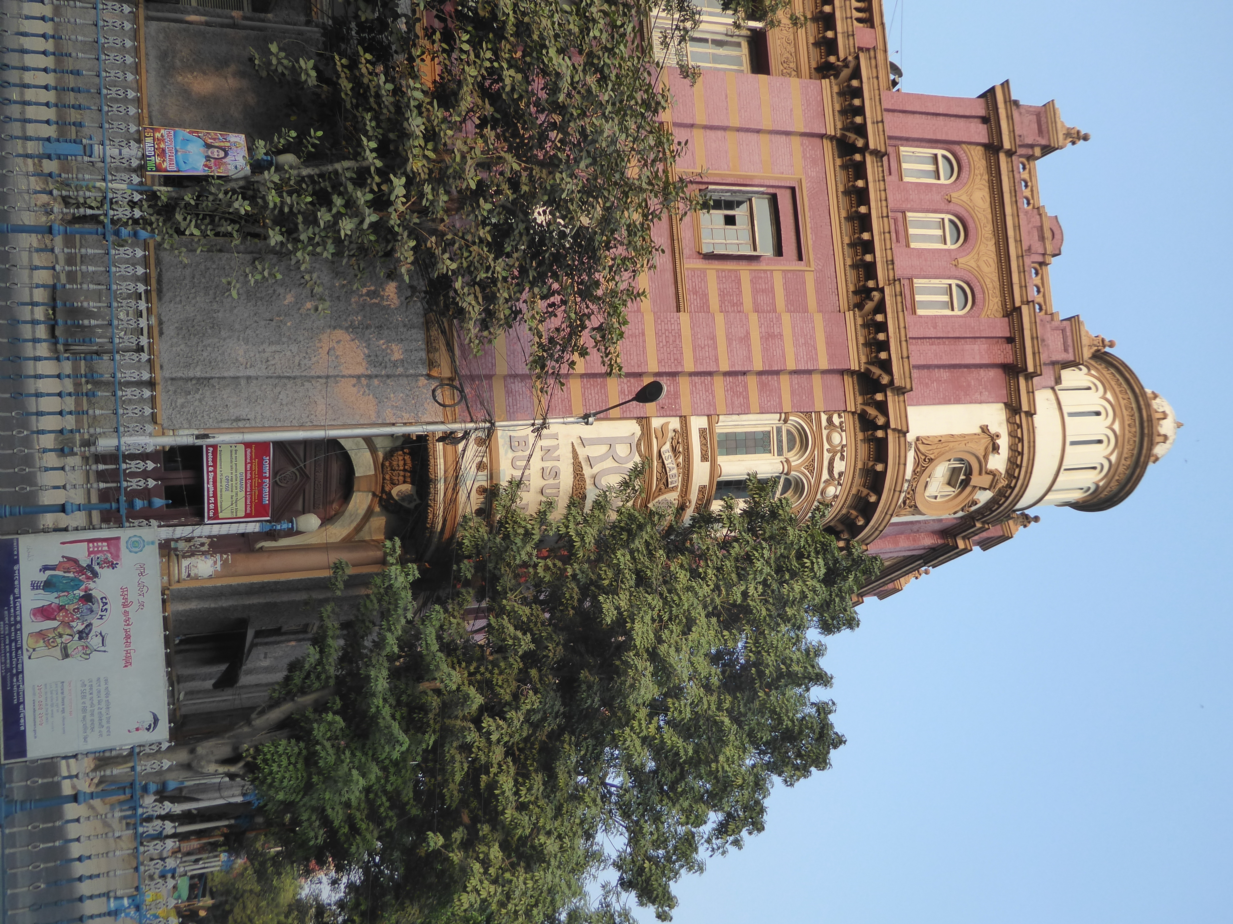 The main entrance is gradually being hidden by foliage.