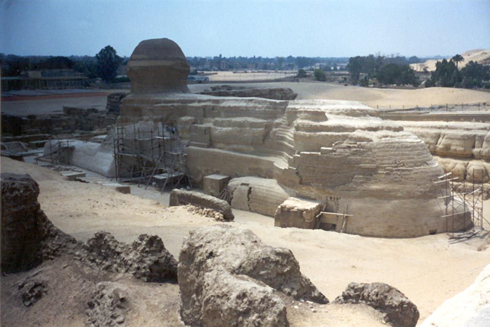 A less familiar view, revealing the volume of rock quarried from her flanks. The Sphinx faces east, looking toward the rising sun. Why? She