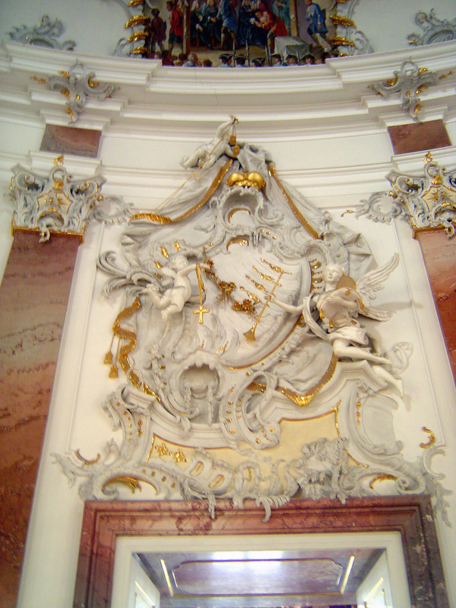 Pevsner says that the cartouche was by a Bavarian stuccoist, Johann Michael Feichtmayr. "Not one part is symmetrical. The main composition i
