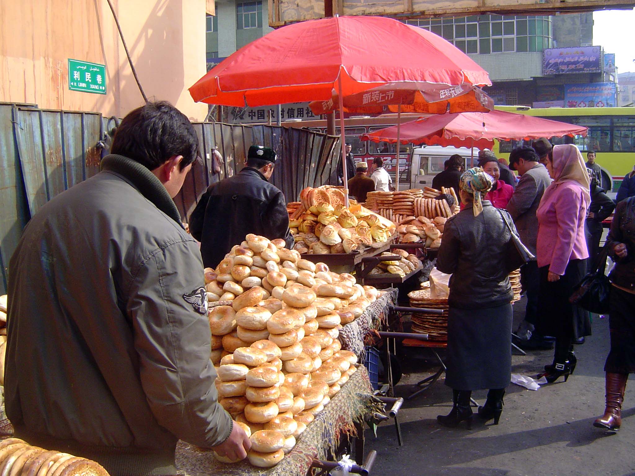 Uighurs are busy outside, here with a variety of breads.