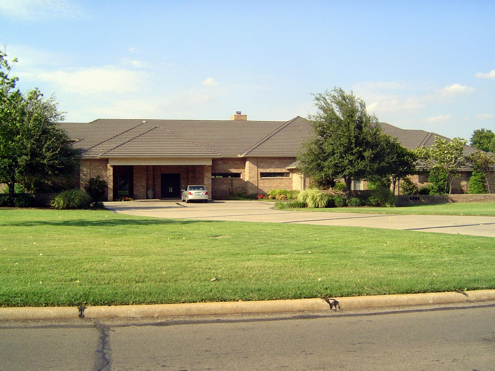 Across the street at 6901 Grand, this house from 1996 hides from the street.