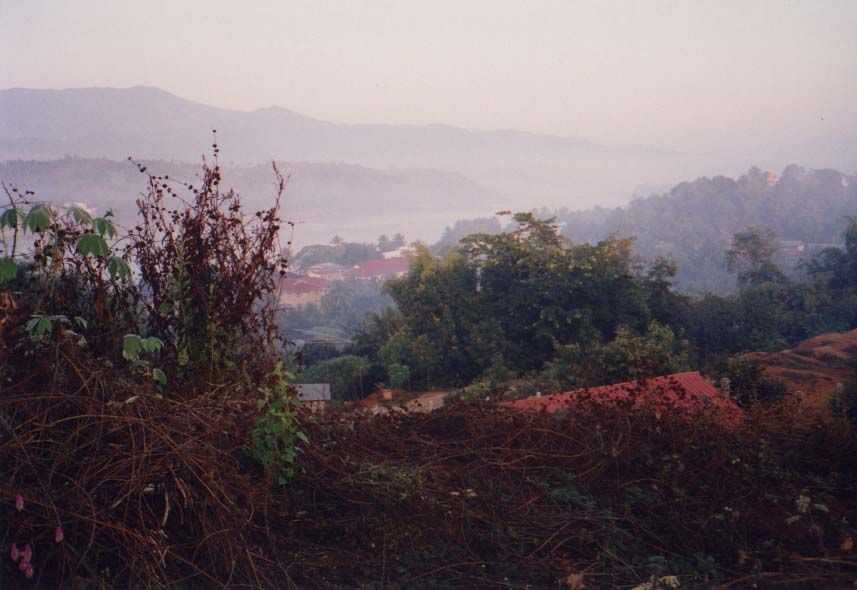 From the top of a nearby hill one sees Thailand, the Mekong, and the roofs of Houayxay.