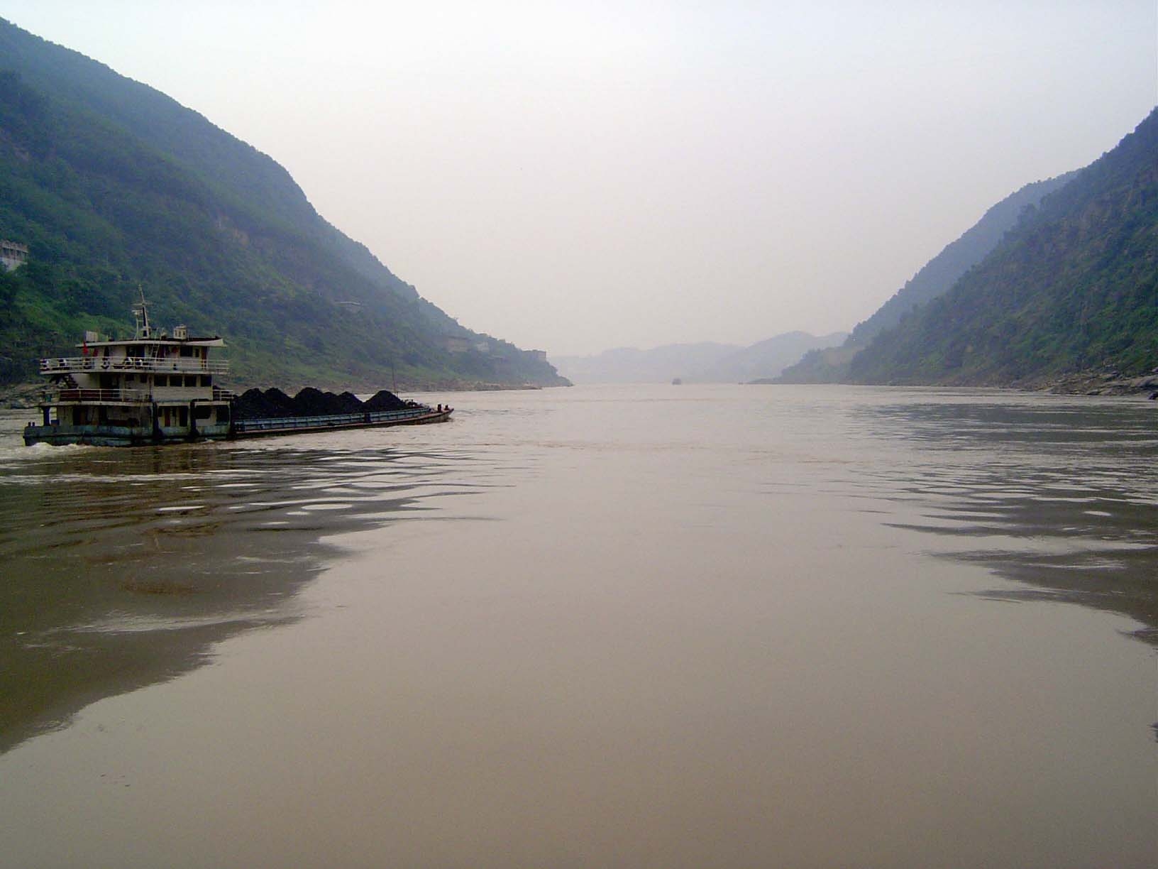 A barge heads towards the river's historic, now flooded gorges.