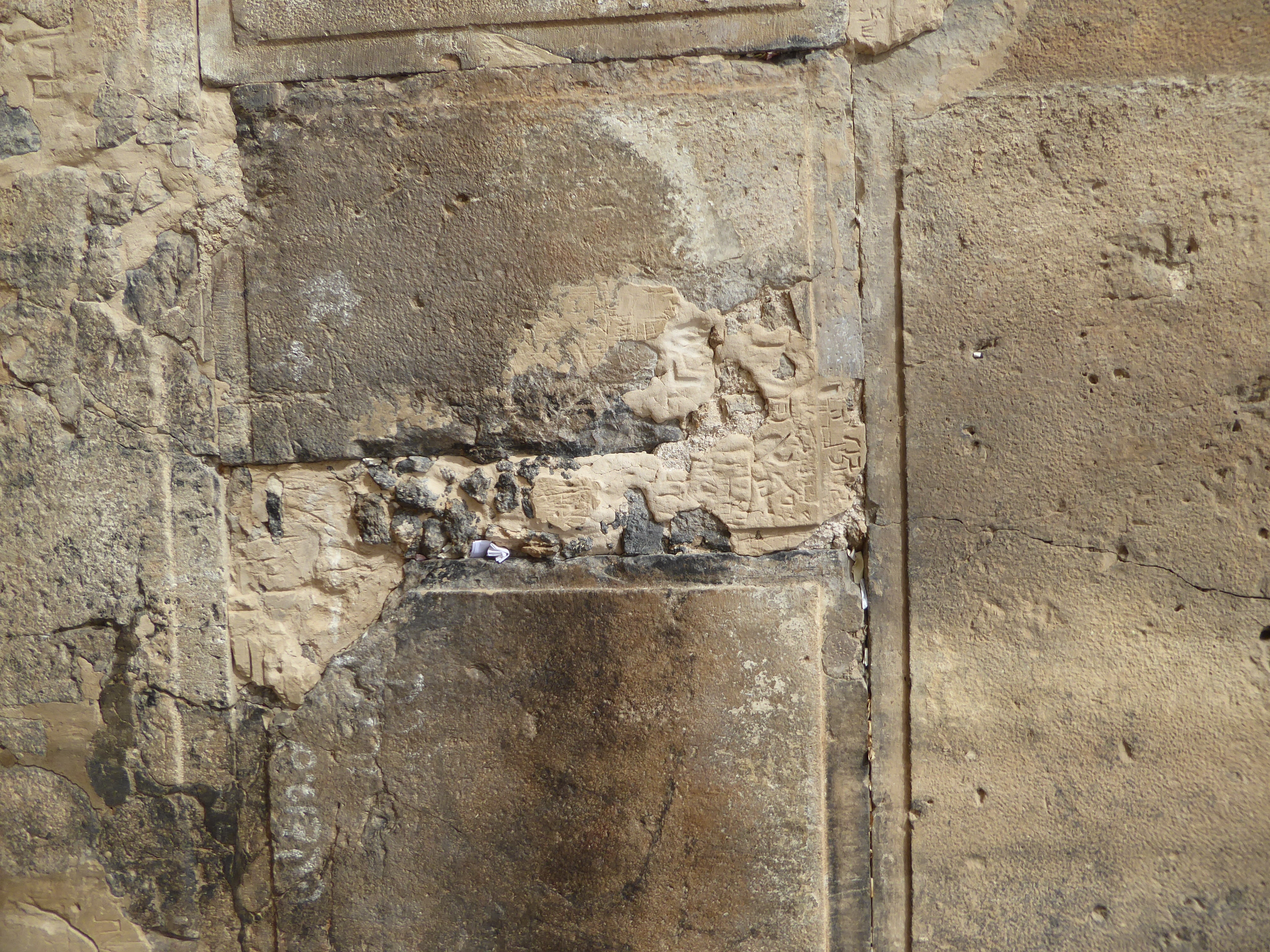 Look, Ma, no mortar. Despite cementing the crack, notes still get squeezed in, just as at Jerusalem's Western Wall.
